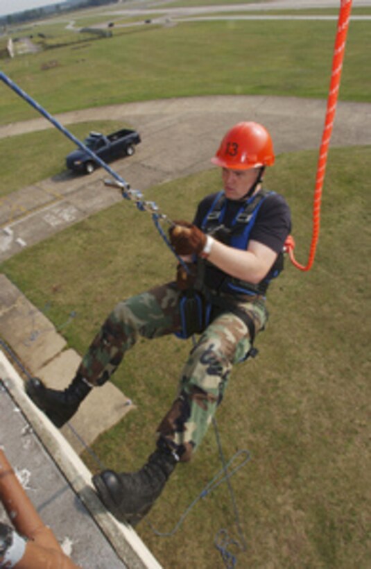 Air Force Airman 1st Class Simeon Brockway prepares to rappel from a tower during a U.S. Air Forces in Europe Fire Academy rescue course on July 18, 2005. Brockway is a fire fighter with the 100th Civil Engineering Squadron, 100th Air Refueling Wing at Royal Air Force RAF Mildenhall, England. 