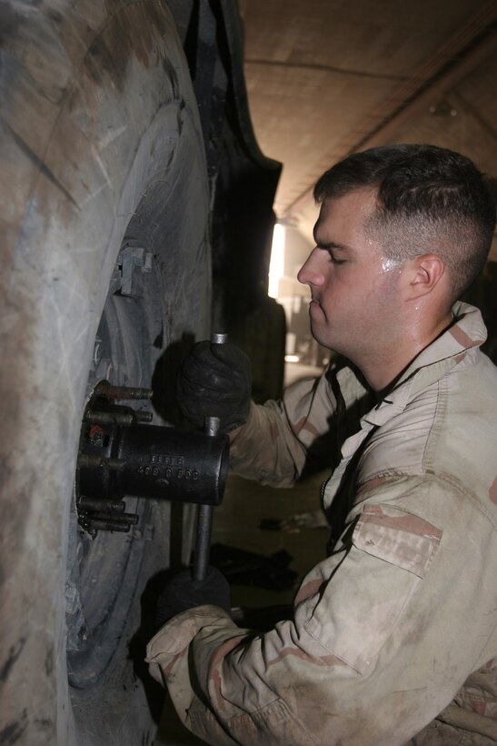 AL TAQADDUM, Iraq ? Private first class Tim Travis, a mechanic with Marine Wing Support Squadron 371, removes a tire from a vehicle during an annual inspection here. The motor transportation maintenance platoon works daily to repair their squadron?s vehicles as well as those of any other unit that needs help with their vehicles around the base.