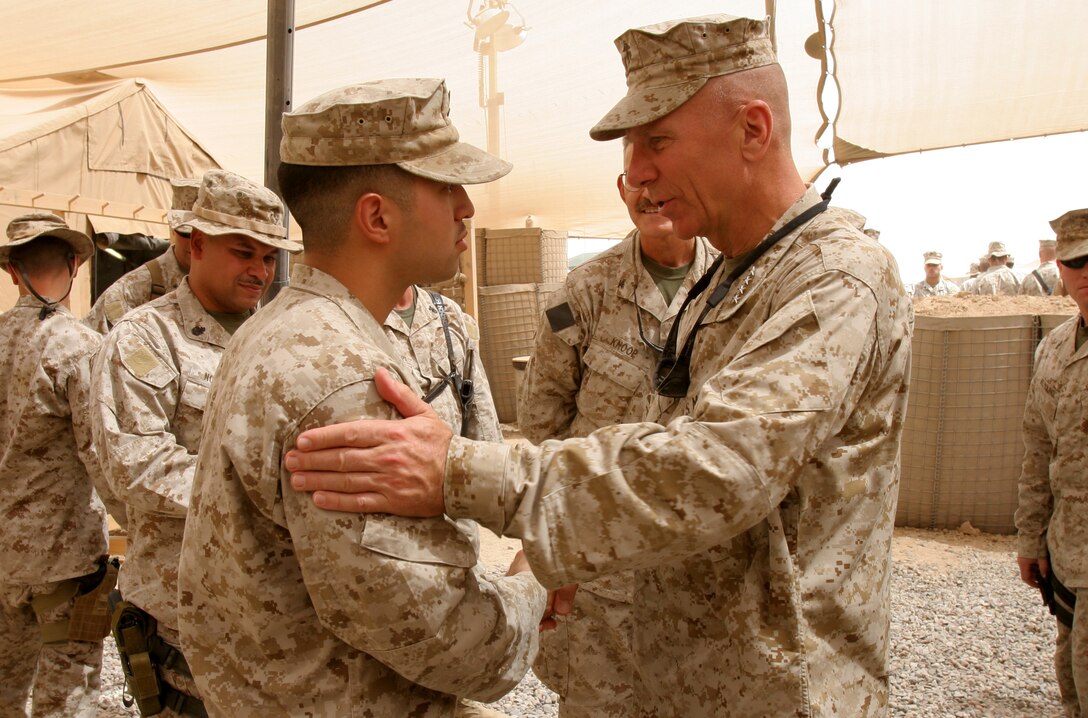 CAMP TAQADDUM, Iraq - Petty Officer 3rd Class Bobby Feireira, 23, of Bridgeport, Conn., shakes hands with General Mike W. Hagee, 33rd Commandant of the Marine Corps, while visiting the sailors of the  2nd Force Service Support Group (Forward) Surgical Shock Trama Platoon on July 24, 2005. Feireira, is a field medical technician assigned to the SSTP.  (U.S.M.C. photo taken by Lance Cpl. Brian A. Jaques)