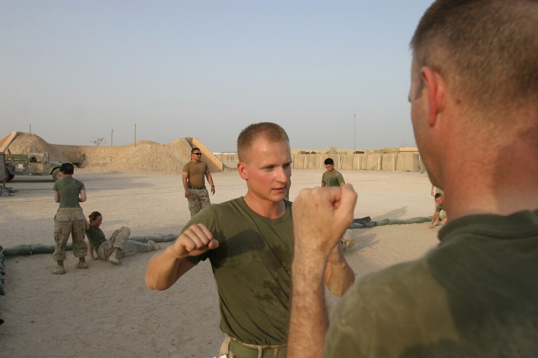 CAMP TAQADDUM, Iraq -- Sergeant Tomasz K. Krolak, a Chicago native and Camp Commandant Unit noncommissioned officer in charge, demonstrates an upper-body strike.  Krolak, born in Brezg Dolny, Poland, deployed to Camp Taqaddum, Iraq, Headquarters and Service Battalion, 2nd Force Service Support Group (Forward).