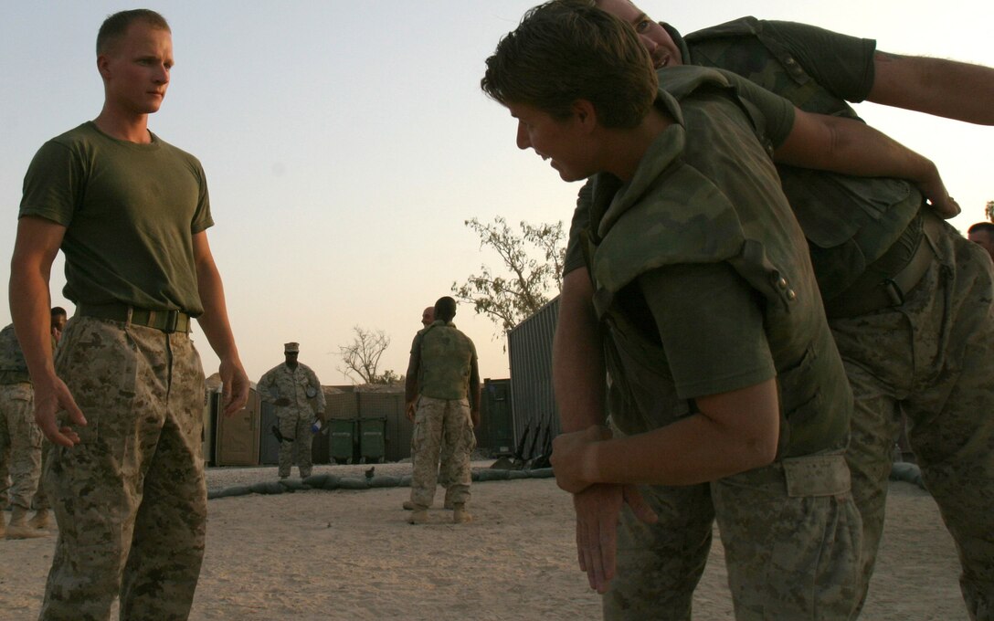 CAMP TAQADDUM, Iraq -- Sergeant Tomasz K. Krolak, a Chicago native and Camp Commandant Unit noncommissioned officer in charge, watches over students of his Marine Corps Martial Arts Program gray belt class.  Krolak, born in Brezg Dolny, Poland, deployed to Camp Taqaddum, Iraq, Headquarters and Service Battalion, 2nd Force Service Support Group (Forward).