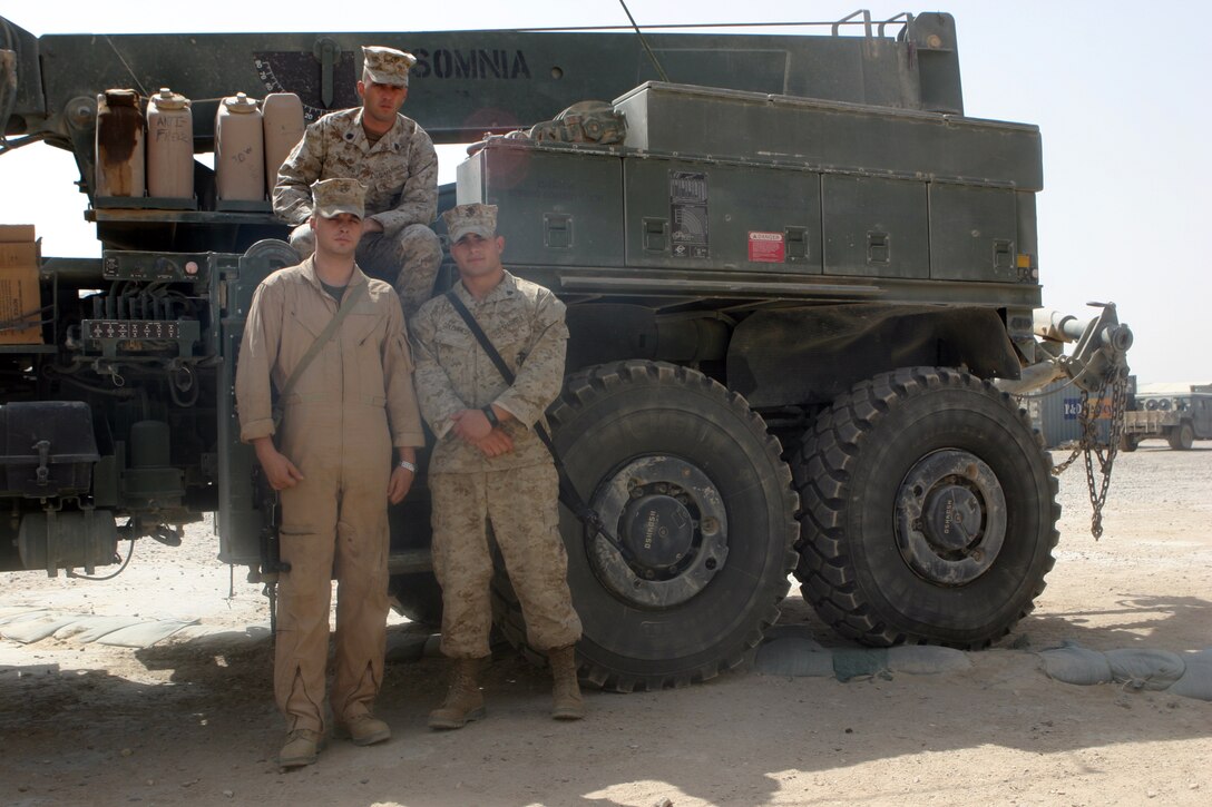 CAMP FALLUJAH, Iraq – Sergeant David A. Taylor (left), Staff Sgt. Chad R. Mueidner (center) and Sgt. Clifford A. Golembieski, enlisted leaders of Combat Logistics Battalion 8, 2nd Force Service Support Group (Forward)’s wrecker section pose next to one of the section’s wrecker trucks. The Marines of the section are responsible for providing vehicle recovery support to all Coalition and Iraqi Security Forces operating within their area of operations. (Photo by Cpl. John E. Lawson Jr.)::n::::n::