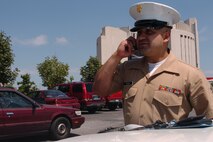 Staff Sgt. Joe I Moran answers a phone call quickly before checking on an applicant's paperwork.