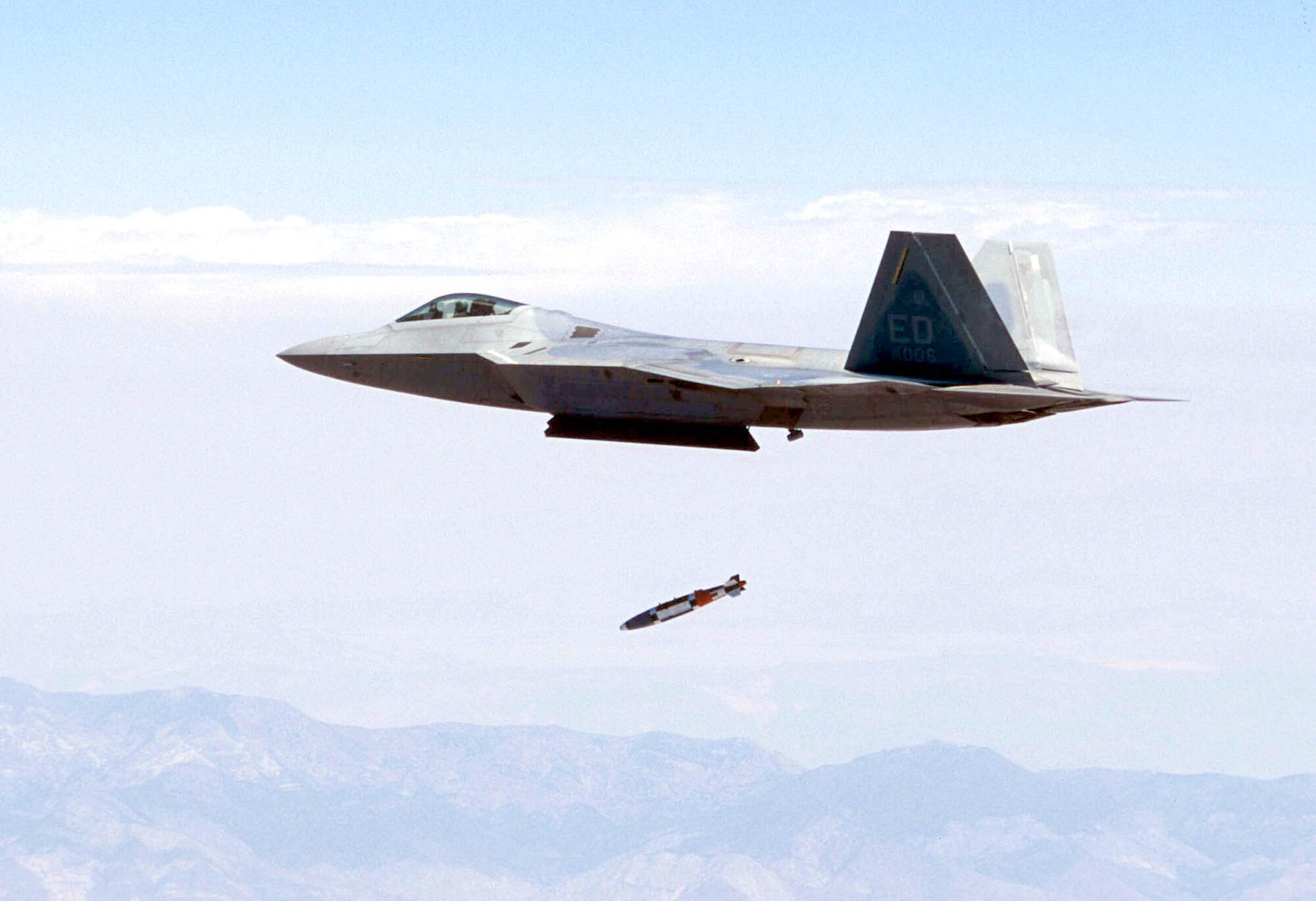 OVER CALIFORNIA -- An F/A-22 Raptor, flown by Maj. John Teichert, releases a guided bomb unit-32 1,000-pound joint direct attack munitions at supersonic speed for the first time near California's Panamint Mountain range.  Major Teichert is a test pilot assigned to the 411th Flight Test Squadron at Edwards Air Force Base, Calif.  (U.S. Air Force photo by Darin Russell)