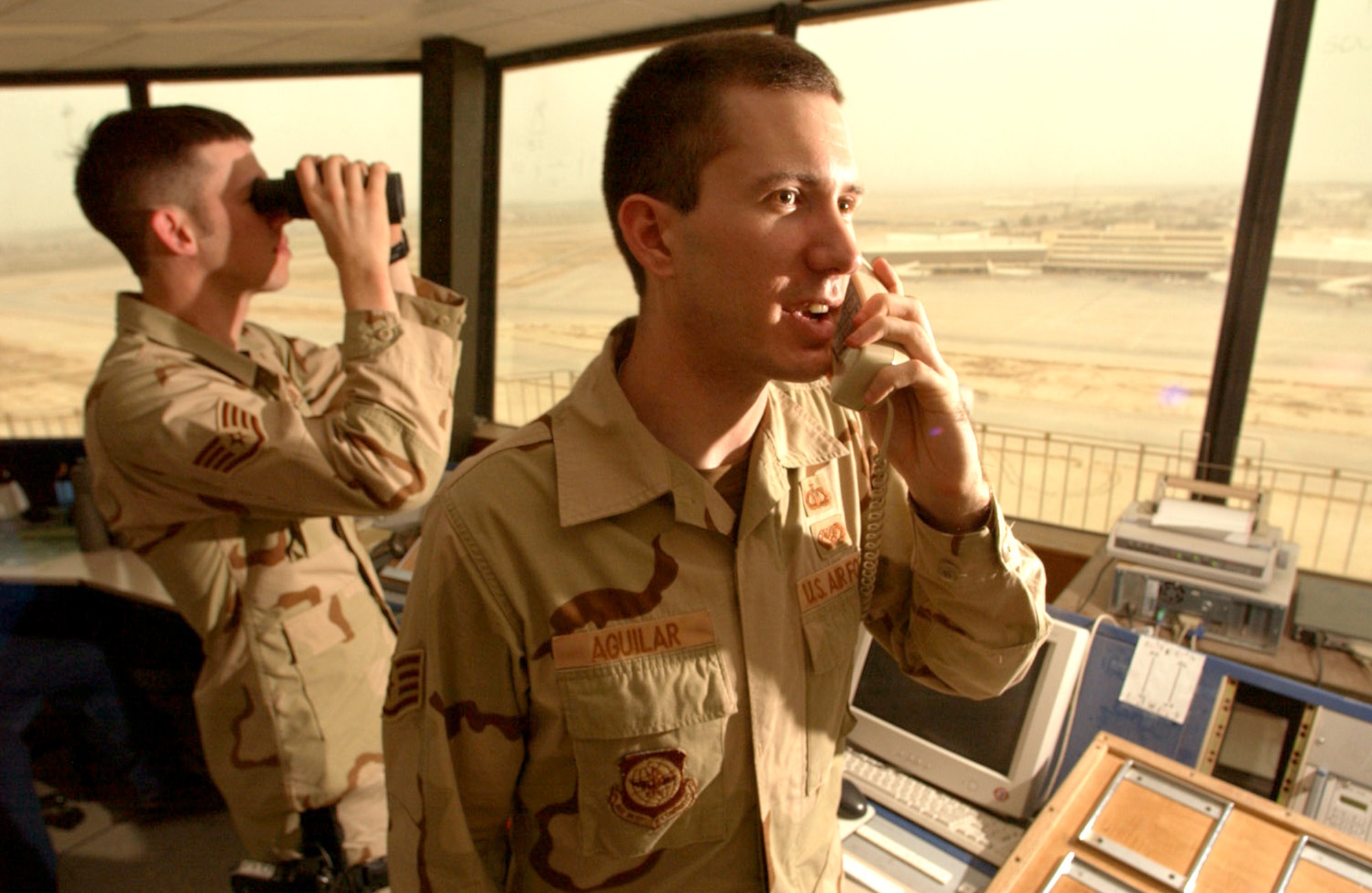 BAGHDAD, Iraq -- Staff Sgts. Dale Drake (left) and Charles Aguilar partner with Iraqi air traffic controllers to keep the sky over Baghdad International Airport safe.  In June, the 447th Air Expeditionary Group's airfield operations flight Airmen successfully coordinated the safe arrival and departure of more than 9,600 military flights.  (U.S. Air Force photo by Master Sgt Scott Wagers)