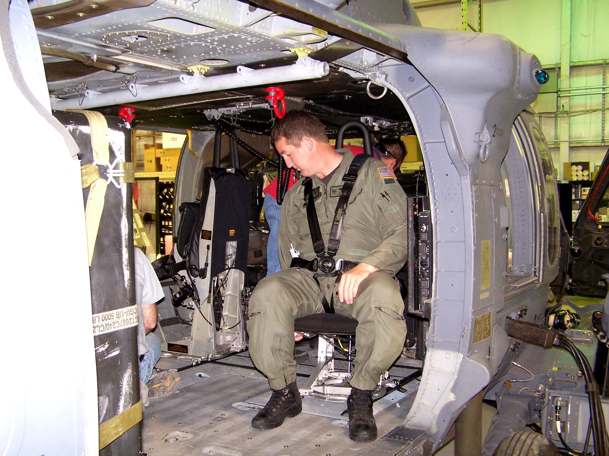 DAVIS-MONTHAN AIR FORCE BASE, Ariz. -- Senior Master Sgt. Michael Flake checks out the new, more ergonomic crew cabin seats being installed in Air Force Reserve Command HH-60G Pave Hawk helicopters.  By the end of the year, all 15 of the command's HH-60Gs will have new seats as well as new fuel tanks in the crew cabin area, giving pararescue and special operations teams more space to operate during combat-search-and-rescue missions.  Sergeant Flake is the lead engineer for the seat replacement project and is assigned to the 305th Rescue Squadron here.  (U.S. Air Force photo by Fred Cusick)