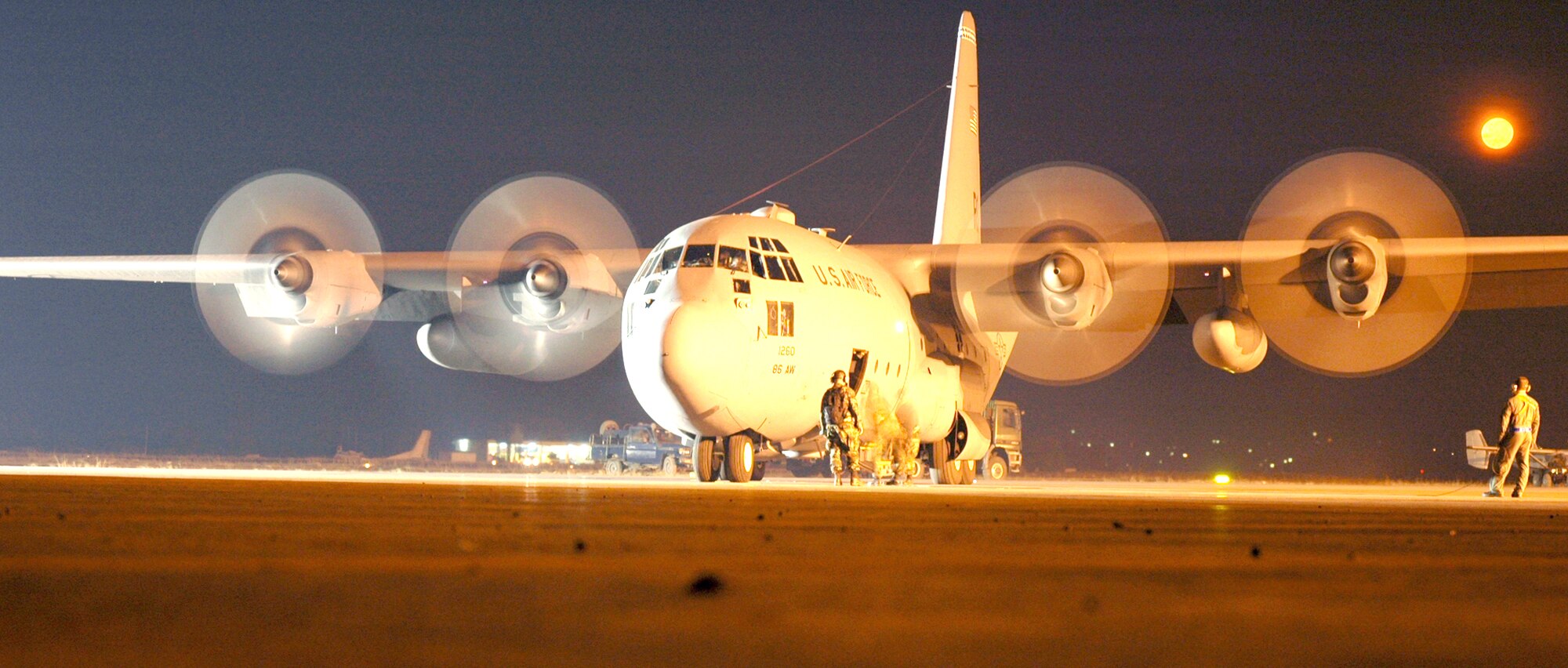 KIGALI INTERNATIONAL AIRPORT, Rwanda - A C-130 Hercules prepares to take off in the early morning hours as members of the 86th Air Expeditionary Group work to get the plane in the air. The 86th Aircraft Maintenance Squadron Airmen are deployed from Ramstein Air Base, Germany. (U.S. Air Force photo by Senior Airman Mike Meares)