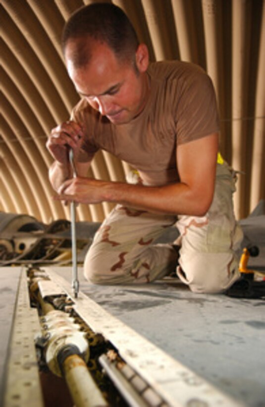 Air Force Tech. Sgt. Edwin Rosado replaces a screw that was damaged in the leading edge flap of an F-16 Fighting Falcon during an inspection at a forward deployed location on July 18, 2005. Rosado, a member of the 379th Expeditionary Maintenance Squadron, is performing an inspection on the aircraft to prevent potential problems or loose items that may come off during flight. 