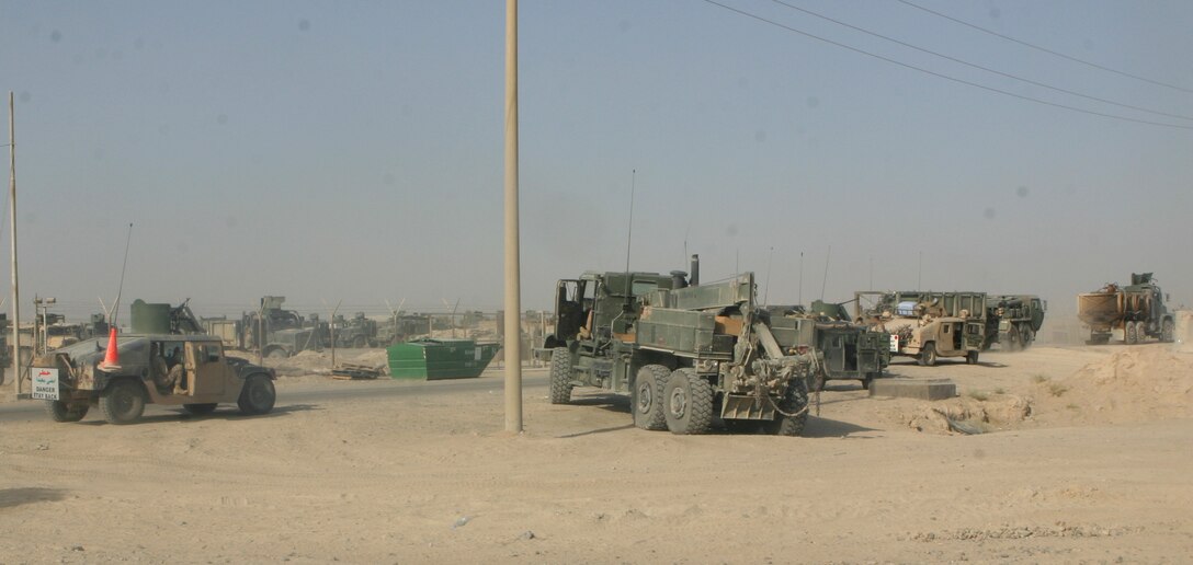 CAMP FALLUJAH, Iraq –A truck from the wrecker section of Combat Logistics Battalion 8, 2nd Force Service Support Group (Forward), stages with a convoy preparing to depart Camp Fallujah. The Marines of the vehicle recovery section attach to convoys to provide wrecker support and support to all Coalition and Iraqi Security Forces operating within their area of operations. (Photo by Cpl. John E. Lawson Jr.)