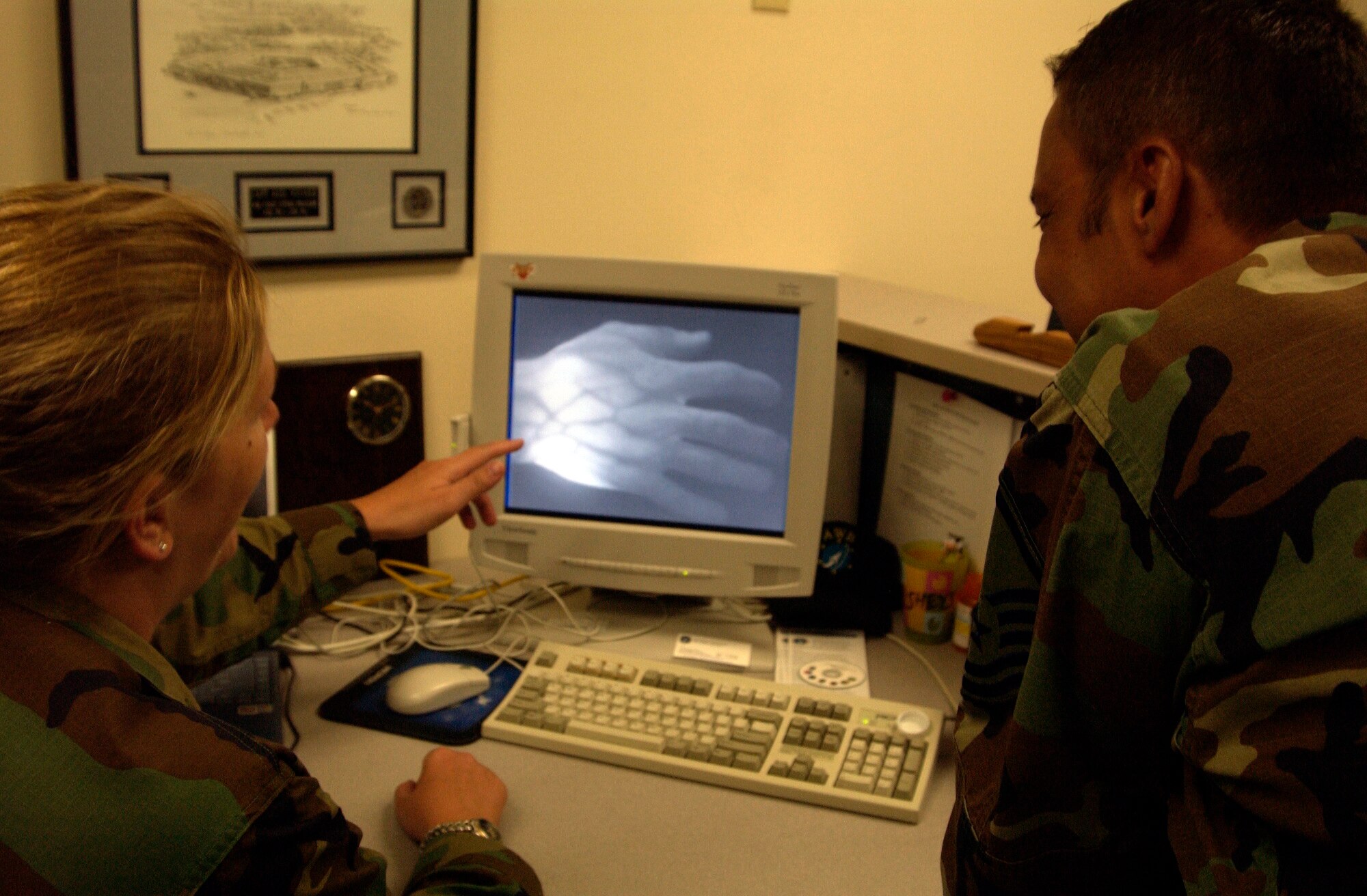 MOUNTAIN HOME AIR FORCE BASE, Idaho -- Capt. Andrea Vinyard (left) explains how the Vein Viewer works to Master Sgt. Danny Deese.  The new technology allows medics to see through human skin to the vascular system.  (U.S. Air Force photo by Staff Sgt. Kathy Parker)
