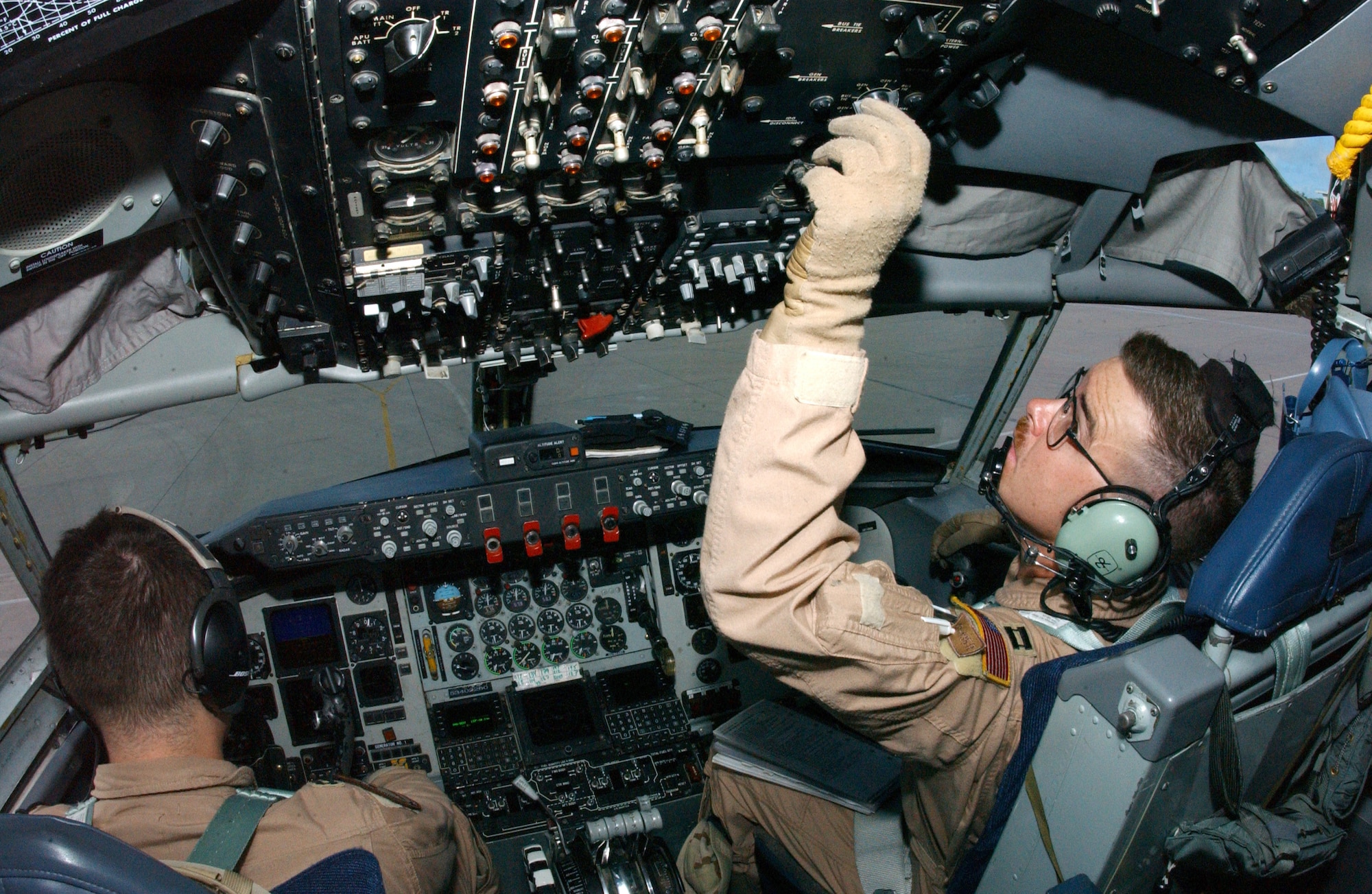 OPERATION ENDURING FREEDOM -- Capts. David Eisenbrey, left, and Ryan Budinko conduct preflight checks in a KC-135 Stratotanker before an air refueling mission at a forward-deployed location. Both are deployed to the 28th Expeditionary Air Refueling Squadron from the 905th Air Refueling Squadron at Grand Forks Air Force Base, N.D. (U.S. Air Force photo by Staff Sgt. Jocelyn Rich)