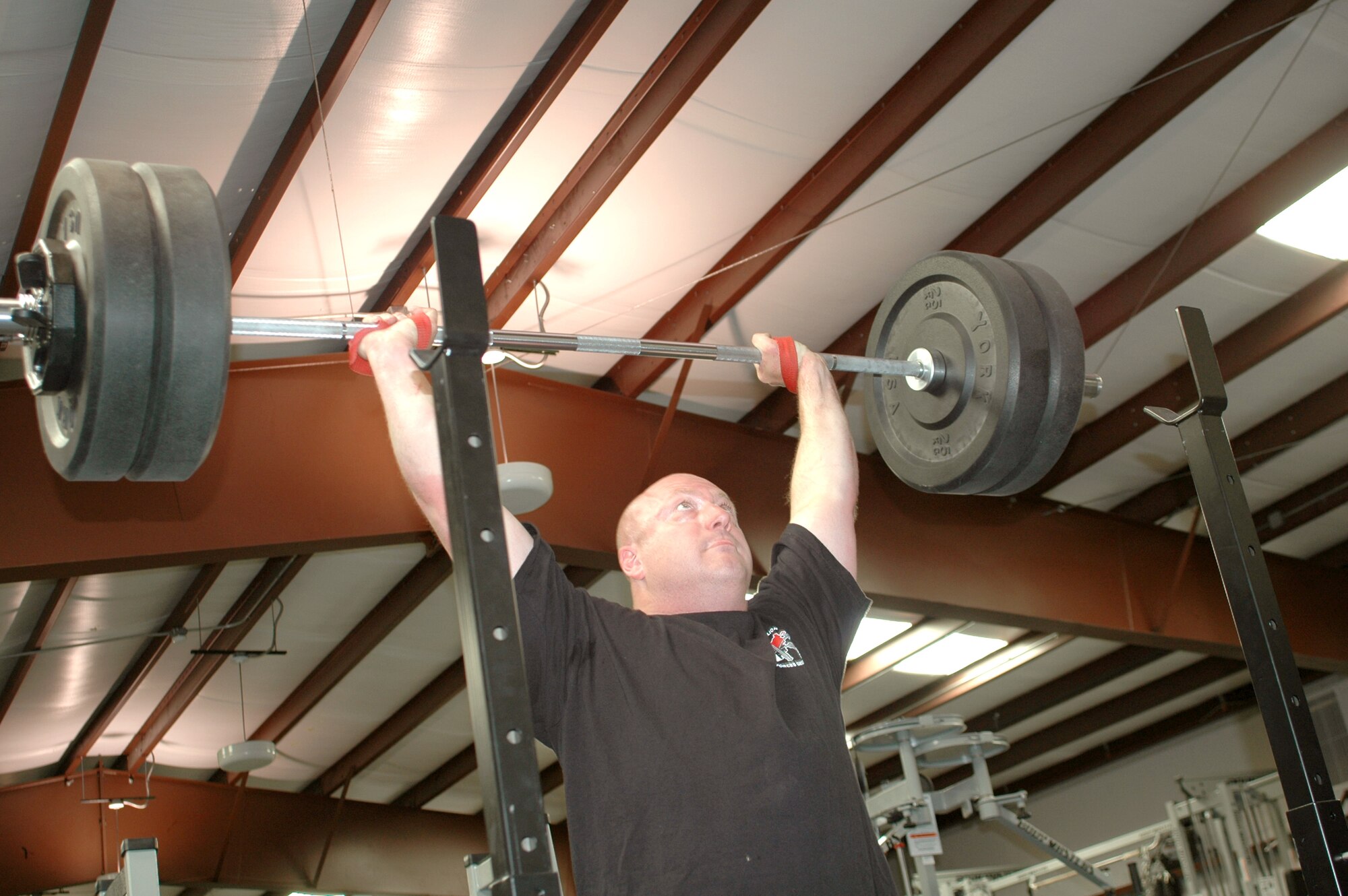 KIRTLAND AIR FORCE BASE, N.M. -- Maj. Michael Ternus lifts nearly 500 pounds during a recent workout at the pararescue school's gym here. Performing "quick cleans" Major Ternus focuses on one of the nuances of this explosive sport requiring guided bursts of energy. He is an Olympic weightlifter and the 377th Logistics Readiness Squadron operations officer. (U.S. Air Force photo by Staff Sgt. Markus M. Maier)