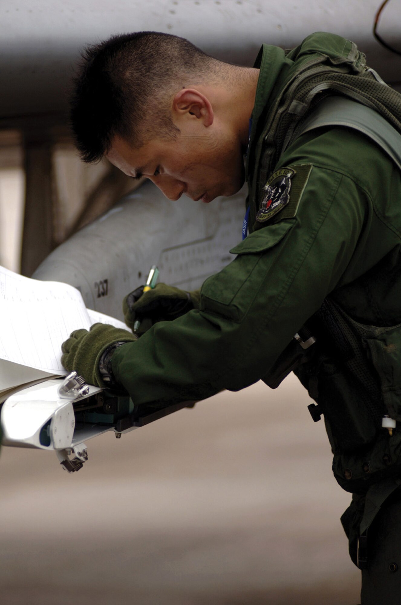 ANDERSEN AIR FORCE BASE, Guam -- Japanese 1st Lt. Nobuhiro Horii performs a preflight inspection before a Cope North mission involving live munitions. This is the first year the Japanese air self-defense force has used live munitions during training missions here. (U.S. Air Force photo by Staff Sgt. Bennie J. Davis III)