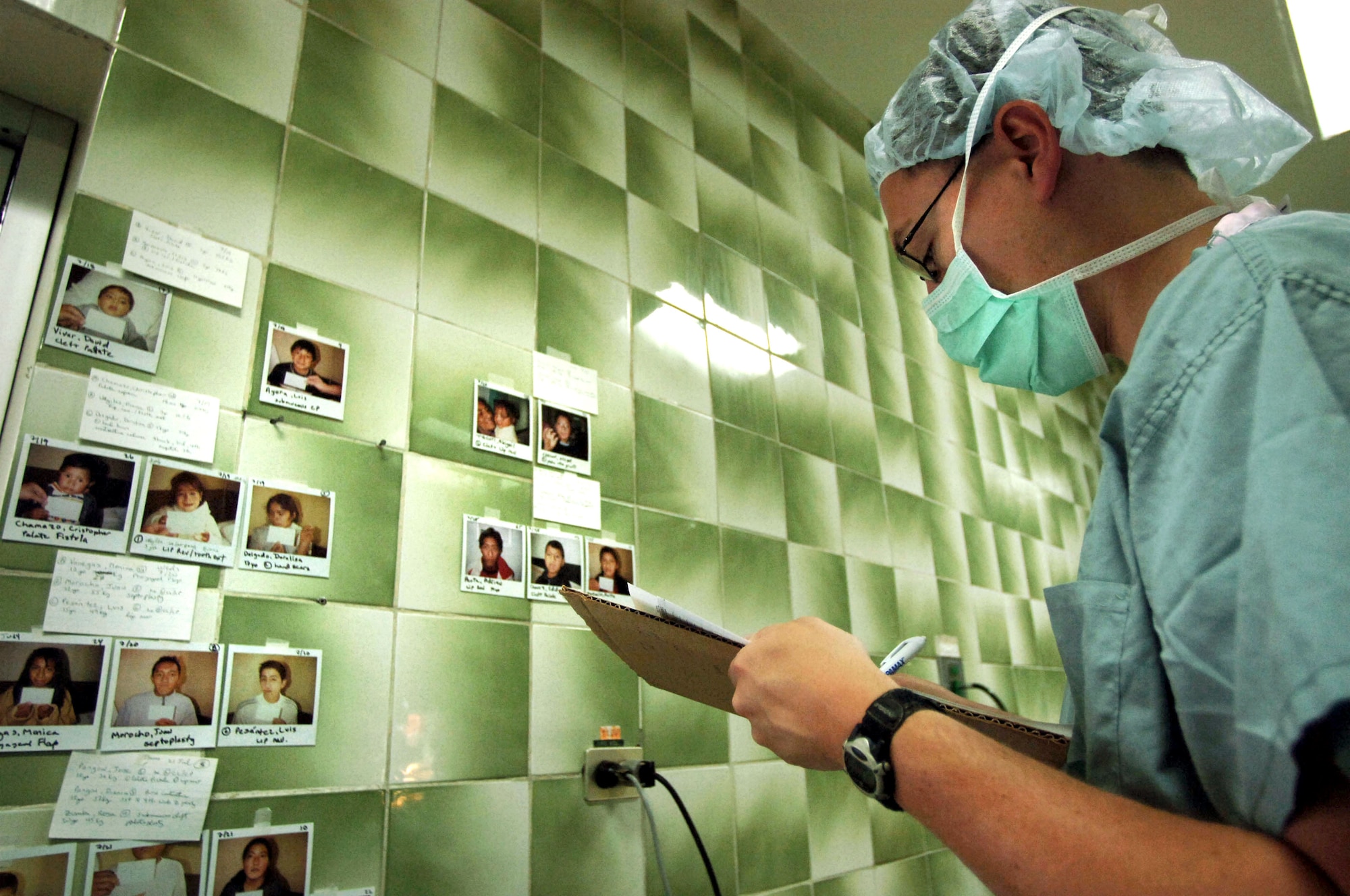 CUENCA, Ecuador -- Maj. (Dr.) McClure Jones keeps record of patients still requiring surgery.  A seven-person plastic surgery team from Wilford Hall Medical Center at Lackland Air Force Base, Texas, is providing free corrective surgeries to Ecuadorian civilians as part of a 12-day medical readiness training exercise.  (U.S. Air Force photo by Master Sgt. Efrain Gonzalez)