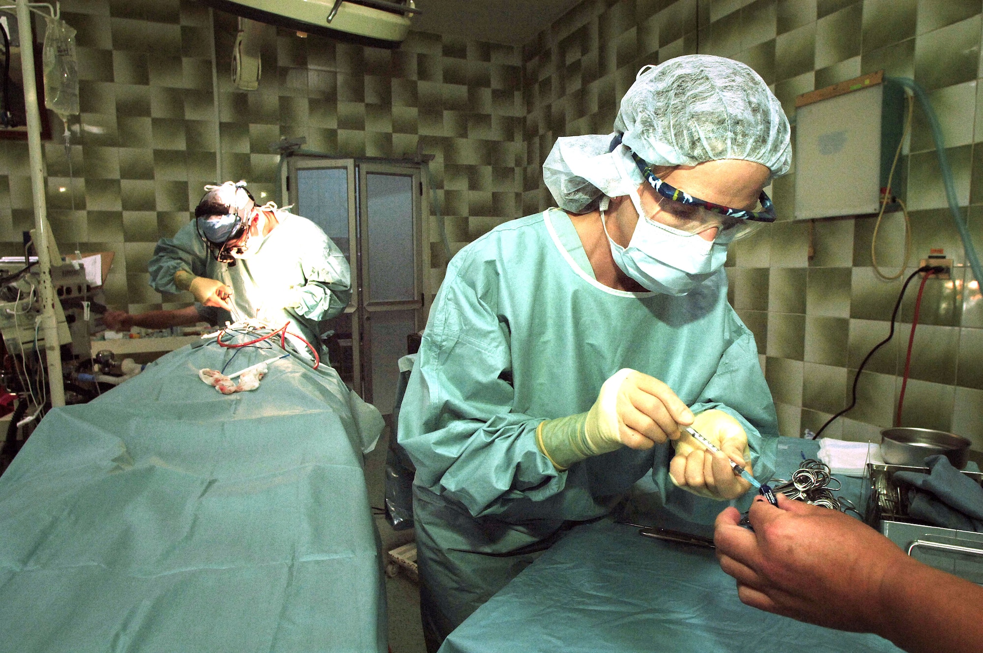 CUENCA, Ecuador -- Master Sgt. Kelly Mathis prepares a syringe during surgery to repair the cleft lip of 14-year-old Adrian Puata.  Sergeant Mathis is with a seven-person plastic surgery team from Wilford Hall Medical Center at Lackland Air Force Base, Texas, providing free corrective surgeries to Ecuadorian civilians as part of a 12-day medical readiness training exercise.  (U.S. Air Force photo by Master Sgt. Efrain Gonzalez)