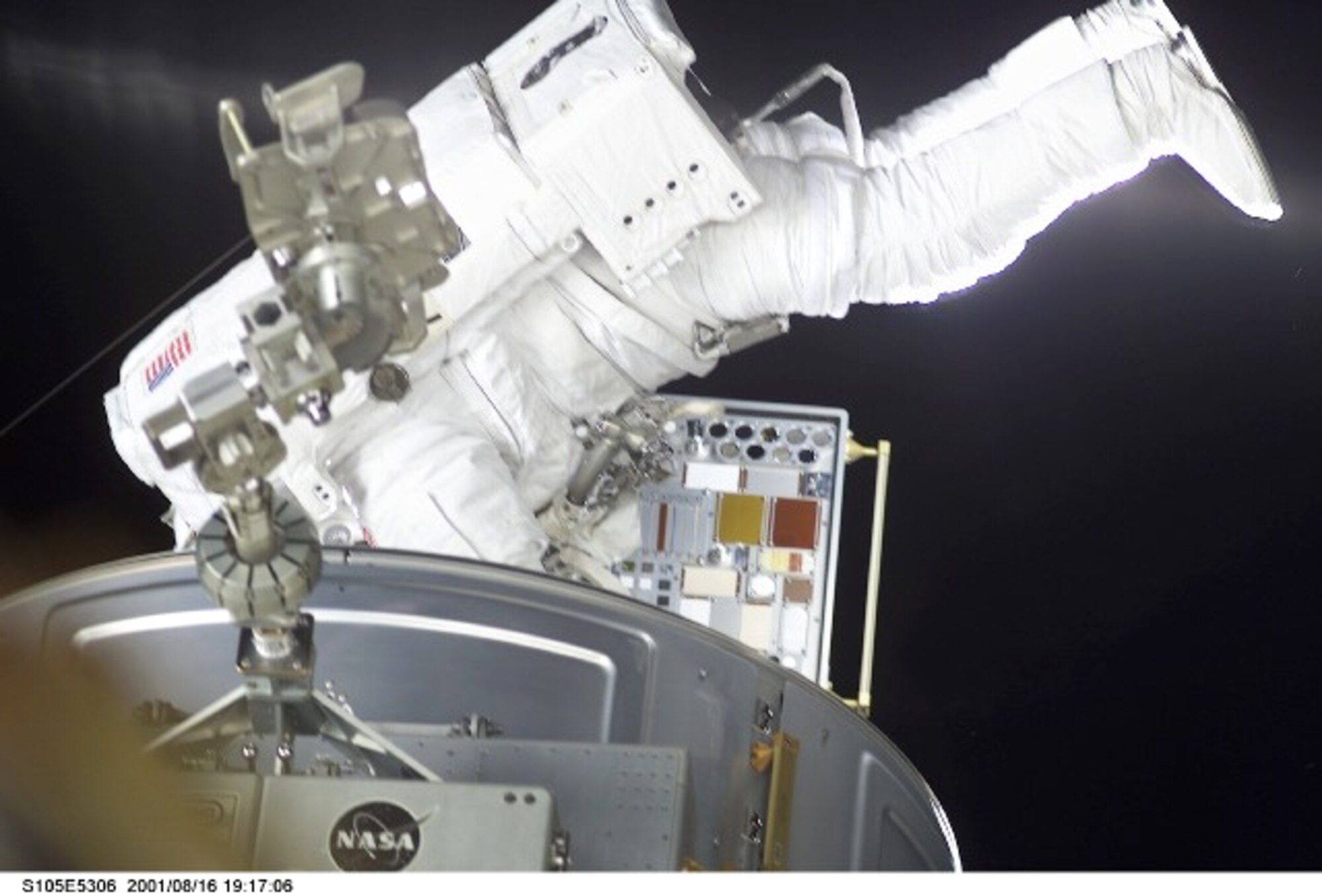 INTERNATIONAL SPACE STATION -- A Space Shuttle Discovery astronaut installs a special carrier on the International Space Station that houses Air Force Research Laboratory experiments.  Laboratory scientists are studying a variety of materials and how they react to the space environment as part of the Materials on the International Space Station Experiment managed by the AFRL at Wright-Patterson Air Force Base, Ohio.(NASA photo)