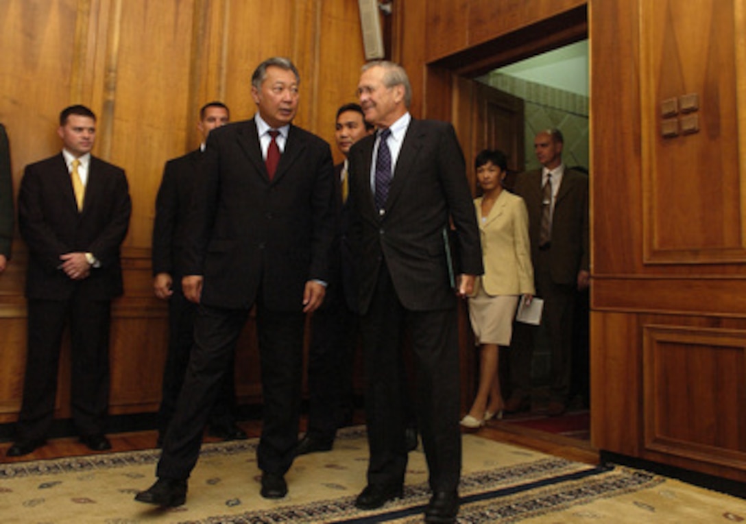Secretary of Defense Donald H. Rumsfeld (right) and Kyrgyzstan President-elect Kurmanbek Bakijev talk informally as they move to meeting to discuss bilateral security issues at Government House in Bishkek, Kyrgyzstan on July 26, 2005. Rumsfeld is in Kyrgyzstan to meet with Bakijev and other senior leaders of the central Asian country. 