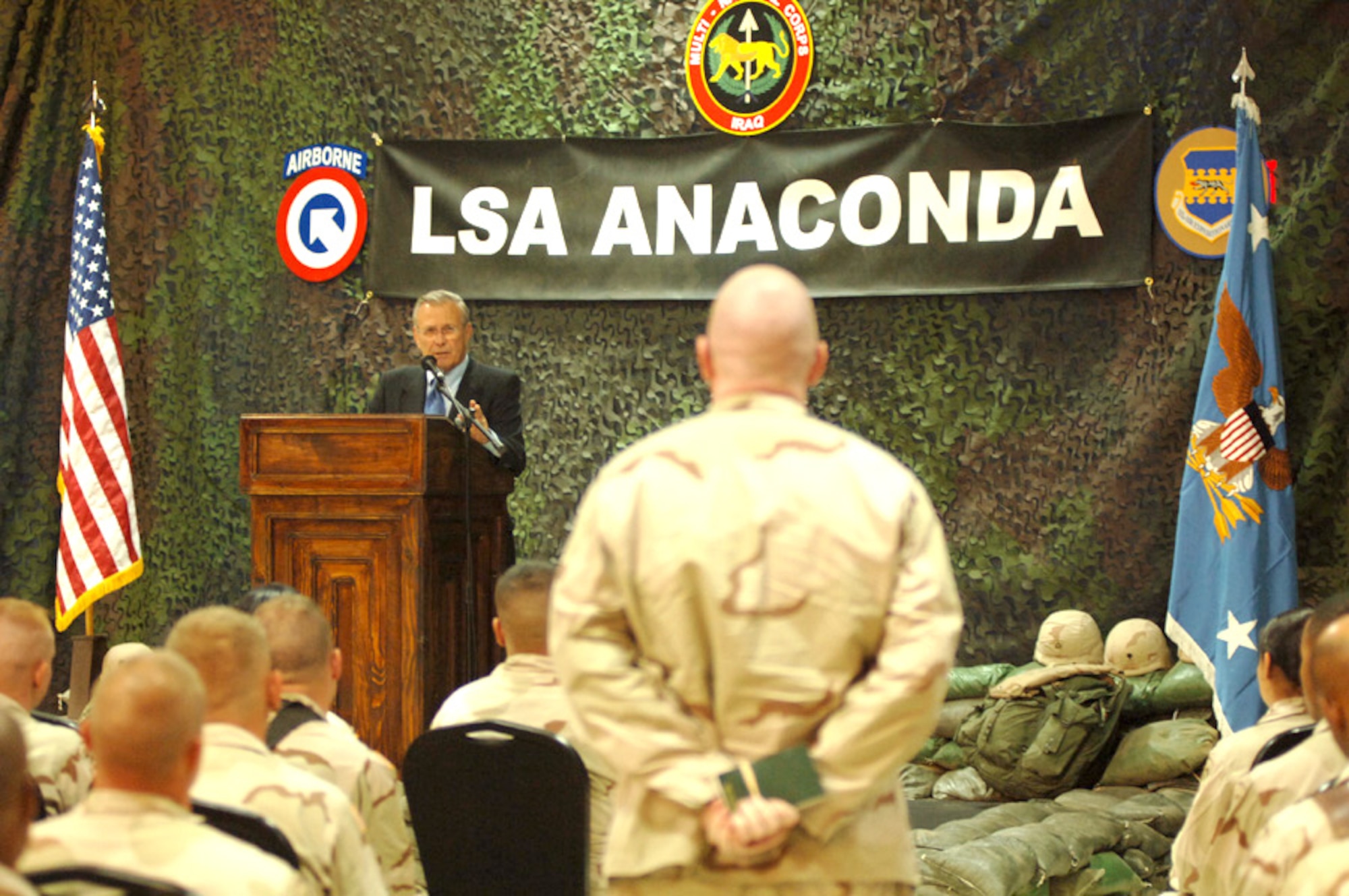 BALAD AIR BASE, Iraq -- Secretary of Defense Donald H. Rumsfeld answers a question during a town hall meeting with Airmen and Soldiers here July 27. While here, the secretary visited the Air Force Theater Hospital where medics treat American, coalition and Iraqi military and Iraqi civilian patients daily.  (U.S. Air Force photo by Staff Sgt. Chad Chisholm)