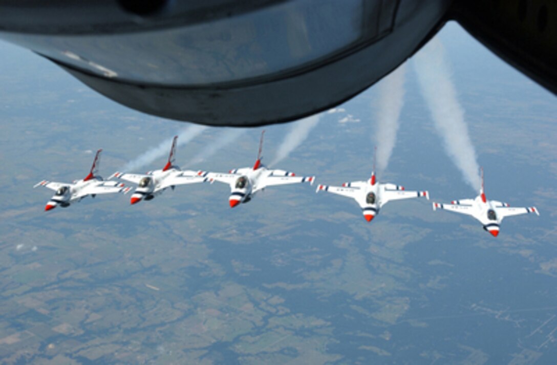 The U.S. Air Force Thunderbirds fly in formation behind a KC-135 Stratotanker before an aerial refueling mission over the U.S. on July 21, 2005. The Stratotanker from Altus Air Force Base, Okla., linked up with the Thunderbirds' F-16 Fighting Falcons for a refueling mission on their way to Terre Haute, Ind. 