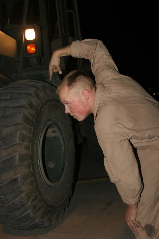 AL ASAD, Iraq ? Corporal Eric Hilker, a loadmaster with Marine Aerial Refueler Transport Squadron 252 and Ithaca, N.Y., native, directs a forklift operator as another pallet gets loaded on board the ?Otis? KC-130J during a general support mission July 28. Hilker is one of two loadmasters who serve on every Hercules crew.