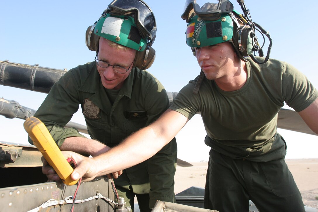 AL ASAD, Iraq ? Corporals James Majors, a native of Salem, Ore., and Joshua Drummond, a Watson, La., native, both avionics technicians with Marine Heavy Helicopter Squadron 465, inspect the wiring connected to the clutch bottle on a CH-53E here July 29. The avionics division is the first shop called to troubleshoot most malfunctions with the aircraft.
