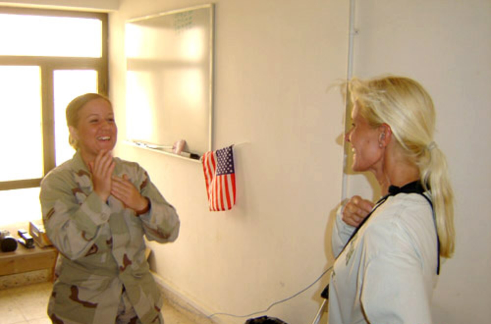 ALI BASE, Iraq -- Airman 1st Class Catherine Dilena gets an unexpected visit here from her mother, Sheri Dilena on July 27. Airman Dilena is a client support administrator with the 407th Expeditionary Civil Engineer Squadron here and is deployed from Scott Air Force Base, Ill. Ms. Dilena is a morale, welfare and recreation coordinator at a nearby forward-deployed location. (U.S. Air Force photo)