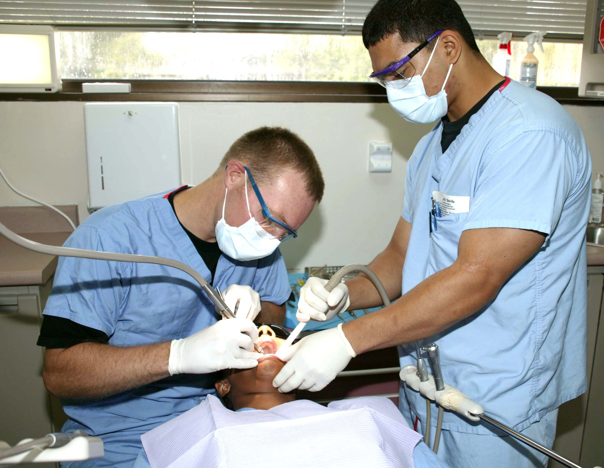 SHAW AIR FORCE BASE, S.C. -- Capt. (Dr.) Rory Frederick (left) and Airman 1st Class Joseph Davila provide dental care to a patient here. They are assigned to the 20th Aeromedical-Dental Squadron. (U.S. Air Force photo by Airman 1st Class Joel Mease)