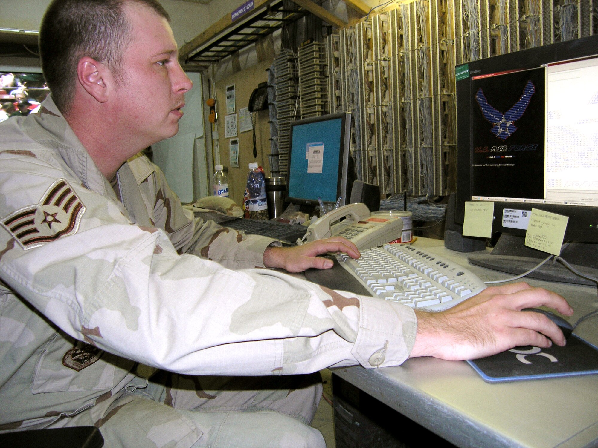 ALI BASE, Iraq -- Staff Sgt. Chris Borslien recreates the Air Force symbol in American standard code for information interchange. He uses the alphanumeric characters to create digital artwork that each computer user sees when he or she logs onto the network. Logon scripts keep the computer safe from viruses and hackers by checking if each computer for current security patches. Sergeant Borslien is a network control center technician with the 407th Expeditionary Communications Squadron deployed from McConnell Air Force Base, Kan. (U.S. Air Force by Tech. Sgt. Melissa Phillips)         