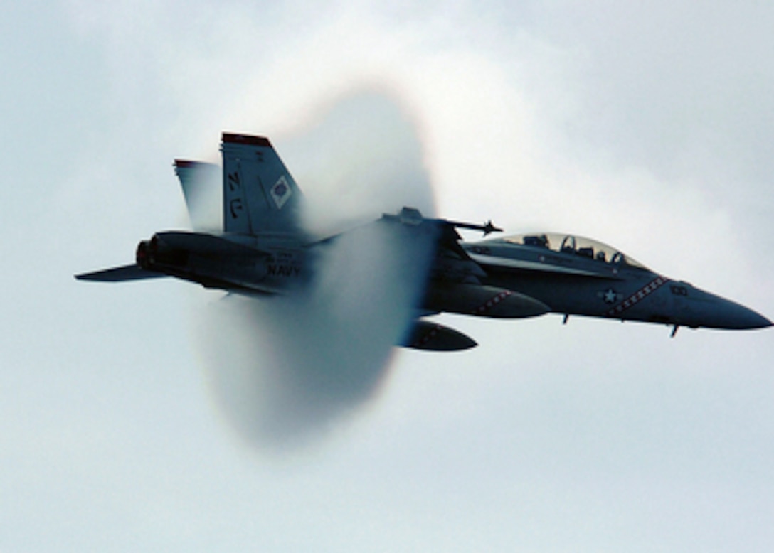 Water vapor builds up around a Navy F/A-18F Super Hornet as it breaks the sound barrier during a fly-by near the aircraft carrier USS Kitty Hawk (CV 63) on July 27, 2005. Kitty Hawk and embarked Carrier Air Wing 5 are currently conducting operations in the Philippine Sea. The Hornet is attached to Strike Fighter Squadron 102 of Naval Air Facility Atsugi, Japan. Kitty Hawk is home ported in Yokosuka, Japan. 