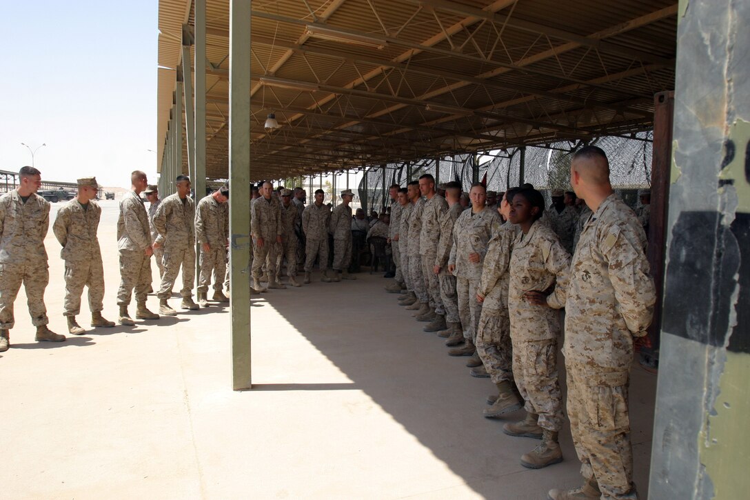AL ASAD, Iraq -- The Marines of Corporals’ Course class 07-05 await the beginning of their graduation ceremony here July 31, 2005.  The Marines spent their last two weeks learning close order drill, techniques of military instruction, sword manual and time management during the course.  Not only were they learning how to be better leaders, but they were also being graded on all events such as two physical fitness tests, close order drill and five uniform inspections, only one of which was planned.