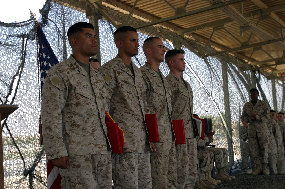 AL ASAD, Iraq -- From left to right: Cpl. John R. Pain, class distinguished honor graduate, Cpl. Daniel R. Eisenmannaviles, second honor graduate, Cpl. Scott N. Turrin, third honor graduate and Lance Cpl. Cade E. Carlton, most motivated Marine of class 07-05, Corporals’ Course.  The Marines participated in the two-week course filled with five uniform inspections, an initial and final physical fitness test and preparing a 10-minute class of techniques of military instruction.
