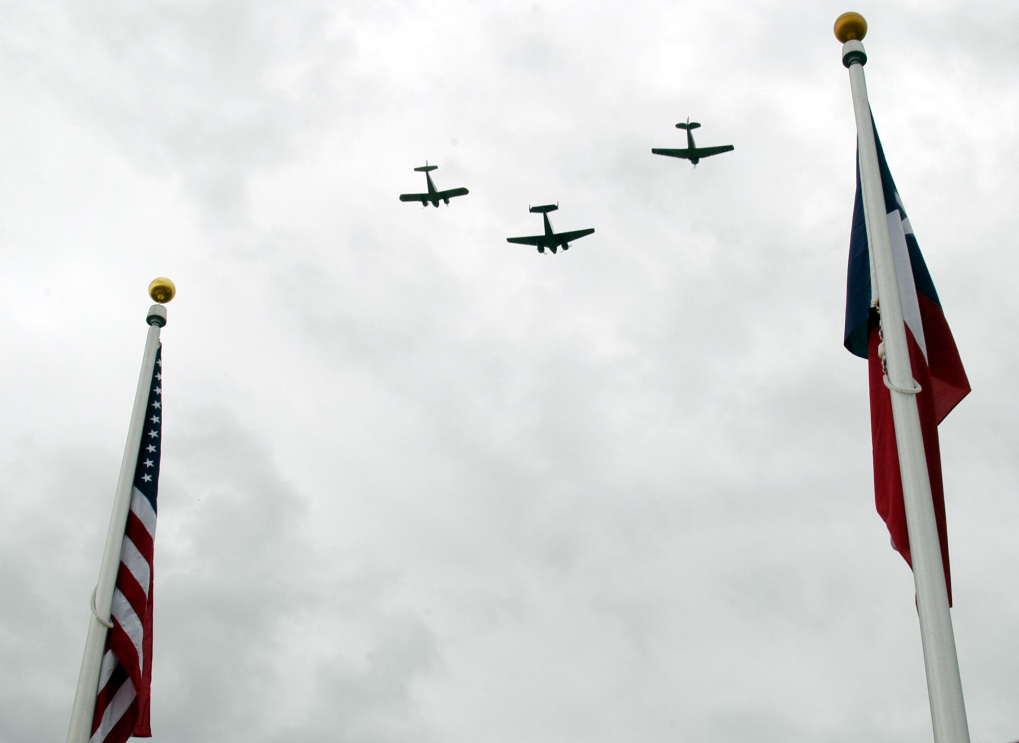 AVENGER FIELD, Texas -- Vintage World War II aircraft perform a missing Women's Airforce Service Pilots formation over the opening ceremonies of the National WASP World War II Museum here May 28.  In service of their country, 38 of the pilots died while performing of their duties.  (U.S. Air Force photo by Senior Airman Matthew Rosine)