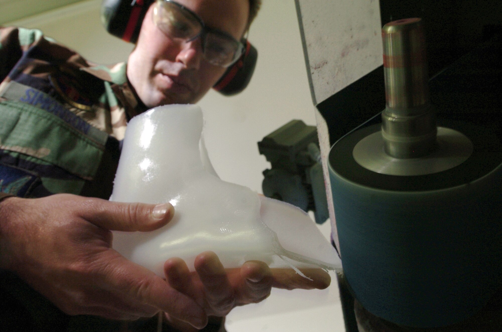 YOKOTA AIR BASE, Japan -- Master Sgt. Nathan Simonson shapes a custom ankle orthosis here.  The orthotic lab technician makes, assembles and repairs orthopedic appliances for patients who require protective support or correction because of bone or muscle injury, impairment disease or deformity.  He is assigned to the 374th Medical Group here.  (U.S. Air Force photo by Master Sgt. Val Gempis)