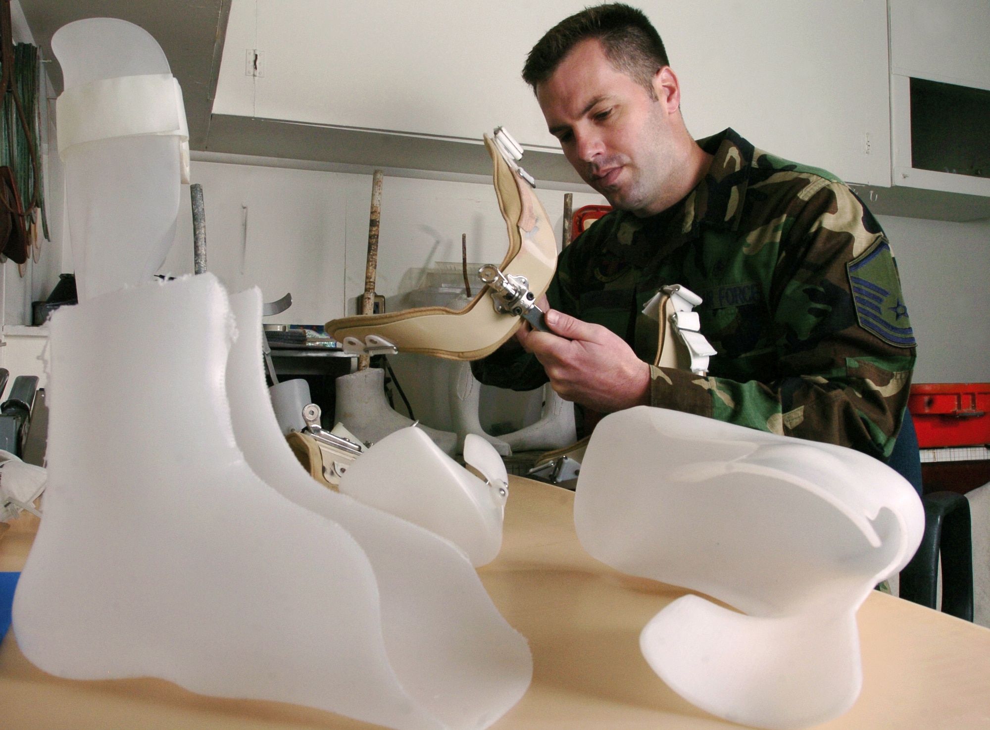 YOKOTA AIR BASE, Japan -- Master Sgt. Nathan Simonson makes a shoulder orthosis.  The orthotic lab technician makes, assembles and repairs orthopedic appliances for patients who require protective support or correction because of bone or muscle injury, impairment disease or deformity.  He is assigned to the 374th Medical Group here.  (U.S. Air Force photo by Master Sgt. Val Gempis)