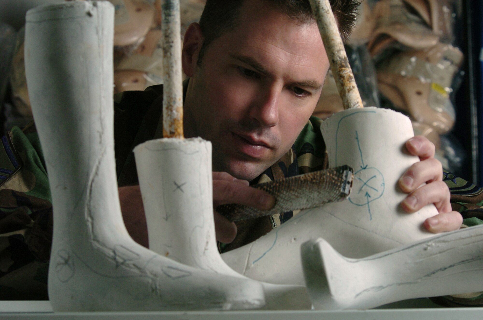 YOKOTA AIR BASE, Japan -- Master Sgt. Nathan Simonson makes adjustments on a positive plaster mold.  The orthotic lab technician makes, assembles and repairs orthopedic appliances for patients who require protective support or correction because of bone or muscle injury, disease or deformity. He is assigned to the 374th Medical Group here. (U.S. Air Force photo by Master Sgt. Val Gempis)