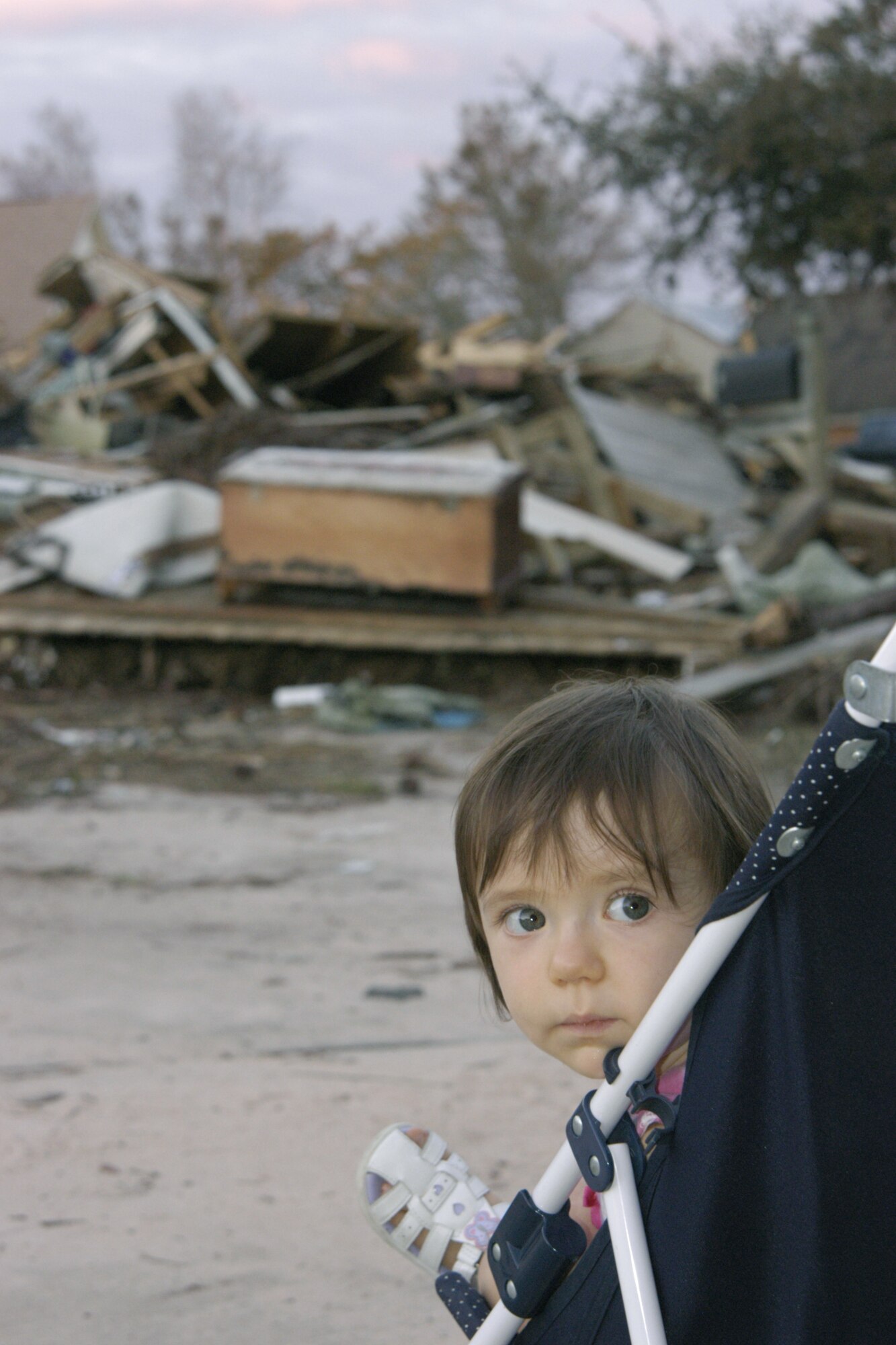FLORIDA -- Grace Mangold, 16 months old at the time, looks away from a pile of debris that once was the contents of her home.  Maj. Charles Mangold visited the site with his daughter just a few days after Hurricane Ivan slammed into this coastal community near Hurlburt Field.  His home received extensive hurricane damage.  He is a 16th Special Operations Wing flight safety officer at Hurlburt Field.  (U.S. Air Force photo by Maj. Alex Carothers)
