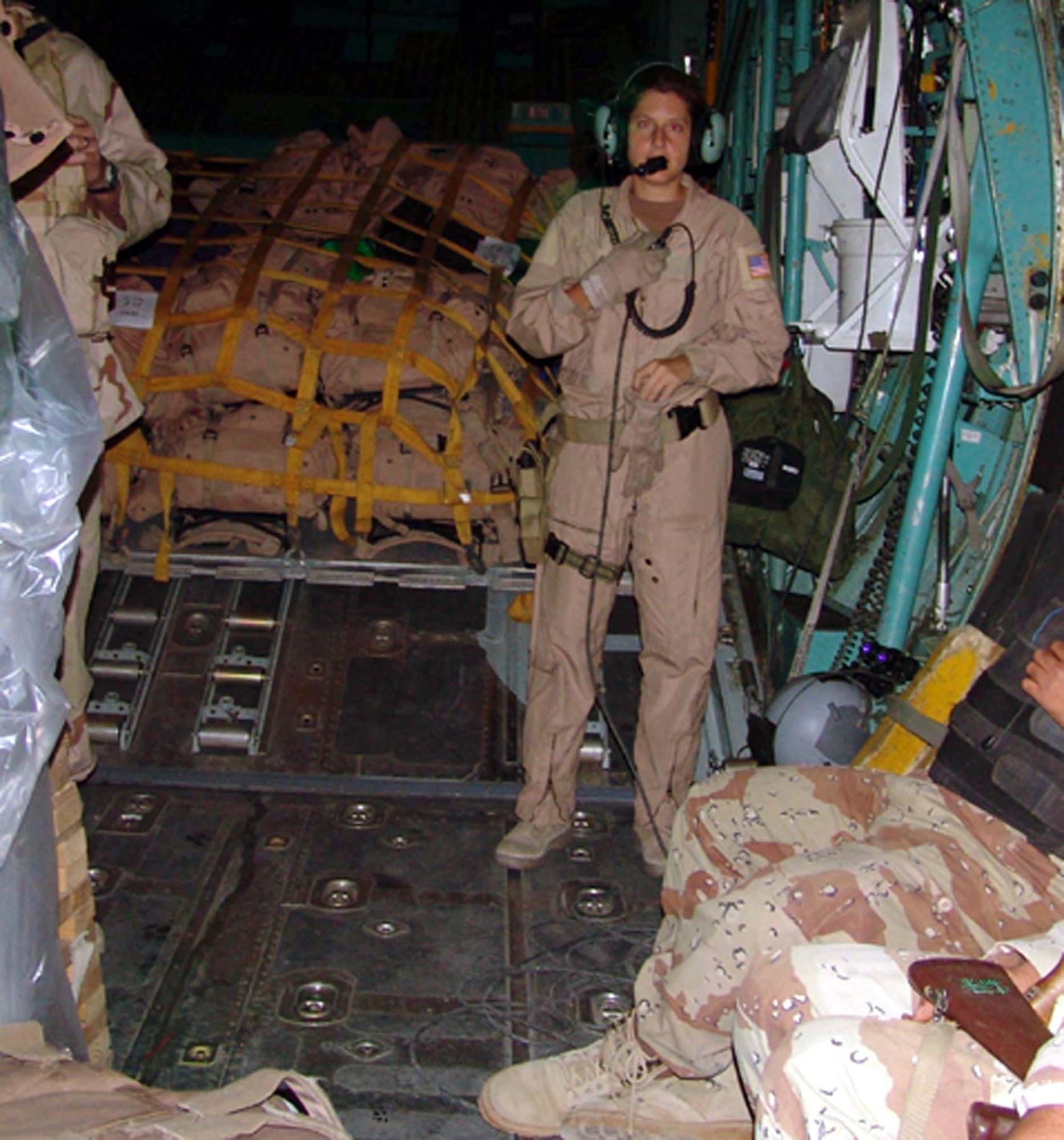 BAGHDAD, Iraq -- Staff Sgt. Jamie Mucciarelli helps Iraqi soldiers get comfortable during a flight on a C-130 Hercules.  She is deployed here from the 41st Airlift Squadron at Pope Air Force Base, N.C.  (U.S. Air Force photo by Tech. Sgt. Brian Davidson)                                                    