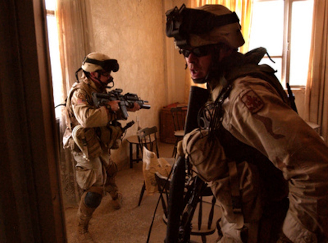 A U.S. Army soldier with Delta Company, 64th Armored Regiment, 4th Brigade, 3rd Infantry Division, yells "room clear" to his squad leader during a raid of an office building used by suspected terrorists, in Baghdad, Iraq, on May 30, 2005. The soldiers captured 12 suspects believed to be behind a plot to use chemical weapons against Iraqi Delegates in the International Zone, Baghdad, Iraq. 