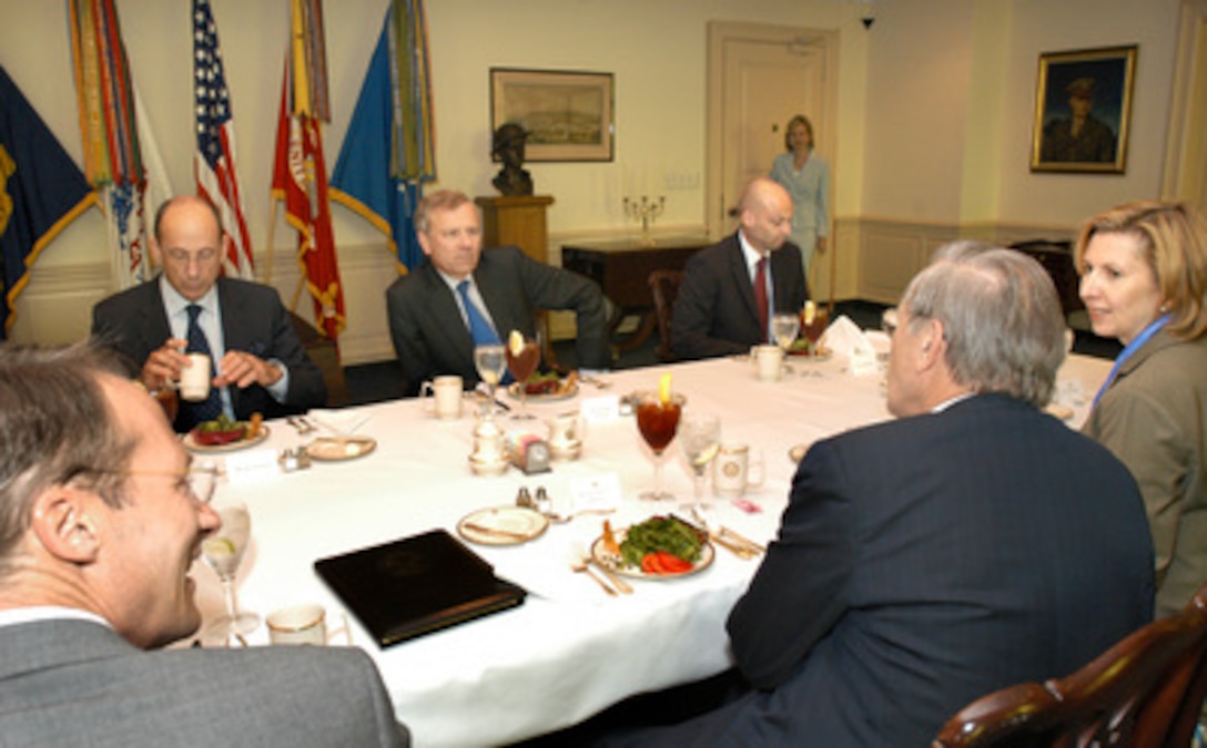 NATO Secretary General Jaap de Hoop Scheffer (center) meets with Secretary of Defense Donald H. Rumsfeld (center, foreground) during a working luncheon in the Pentagon on June 1, 2005. Joining de Hoop Scheffer are Director of the Private Office of the Secretary General Ed Kronenburg (left), and NATO spokesperson Jamaes Appathurai (right). On the U.S. side of the table are Acting U.S. Permanent Representative to NATO John Koenig (left foreground), and Acting Assistant Secretary of Defense for International Security Policy Mira Ricardel (left). 