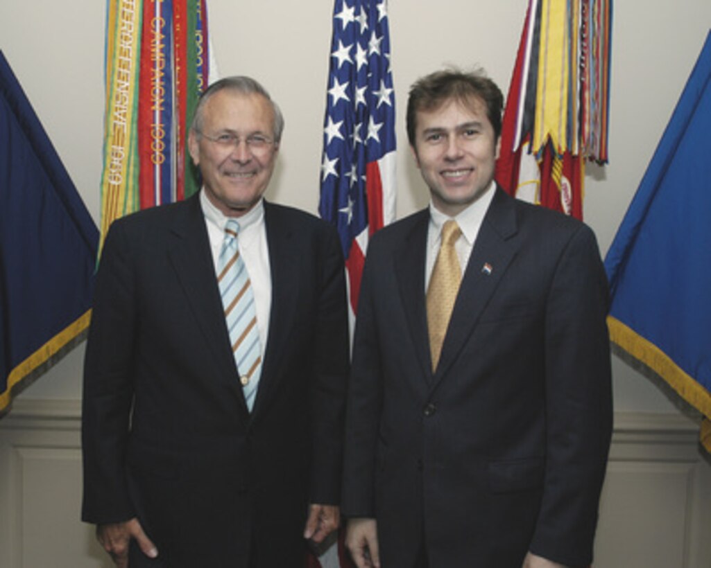 Secretary of Defense Donald H. Rumsfeld (left) and Paraguayan Vice President Luis Castiglioni pose for photographs prior to their meeting in the Pentagon on June 1, 2005. Rumsfeld and Castiglioni are meeting to discuss defense issues of mutual interest. 