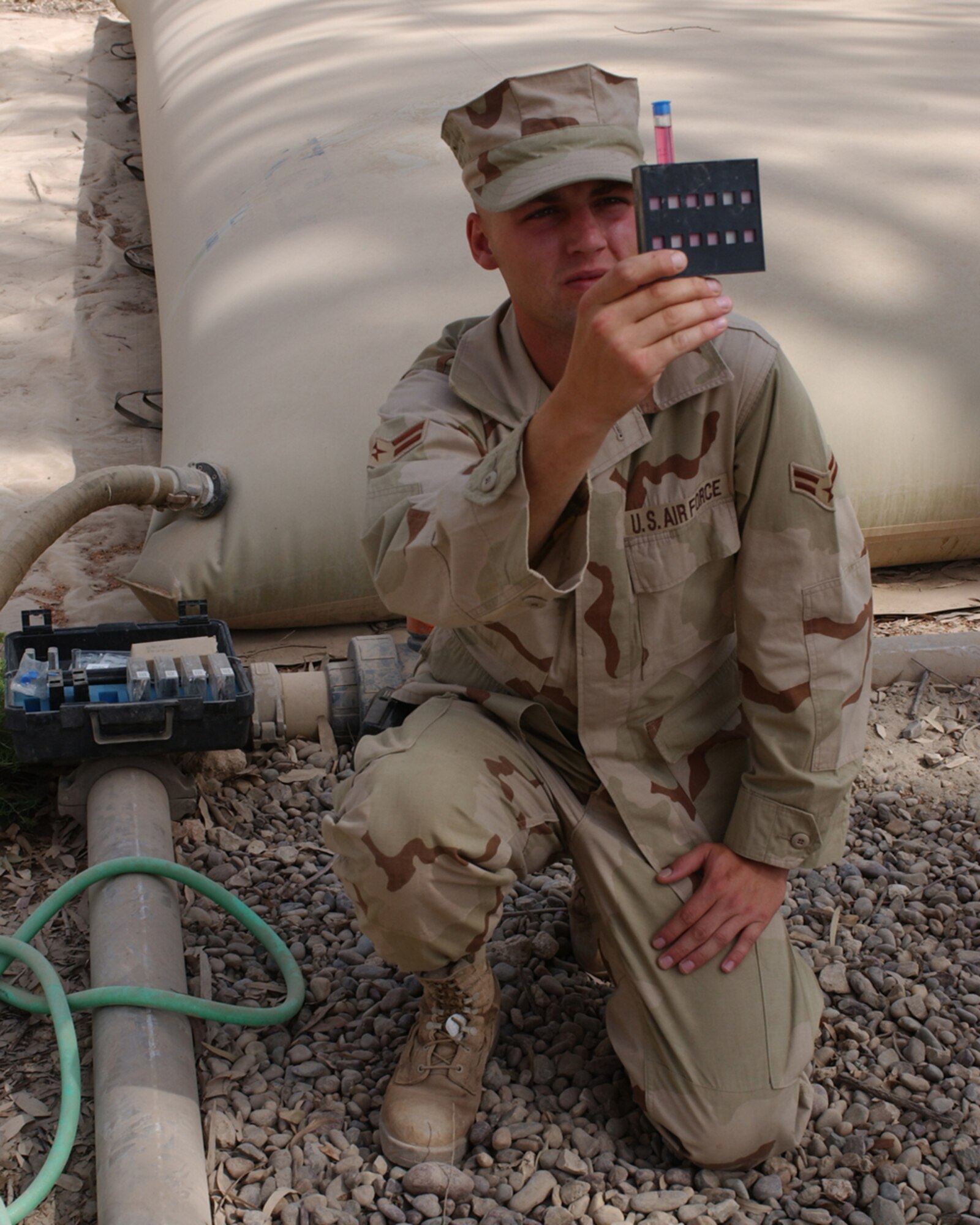 BAGHDAD, Iraq -- Airman 1st Class Timothy Faulkner checks for contaminants in the water supply here.  He is assigned to the 447th Expeditionary Civil Engineer Squadron and is deployed from Kadena Air Base, Japan.  (U.S. Air Force photo by Tech. Sgt. Brian Davidson)                                                    