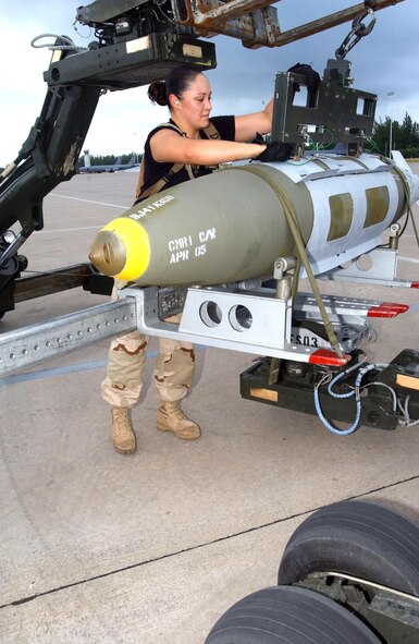 OPERATION ENDURING FREEDOM -- Senior Airman Stephanie Lopez straps a joint-direct attack munitions that will be loaded on a B-52 Stratofortress to a bomb-lift vehicle.  She is a weapons loader with the 40th Expeditionary Maintenance Squadron at a forward-deployed location and is from Minot Air Force Base, N.D.  (U.S. Air Force photo by Staff Sgt. Jocelyn Rich)