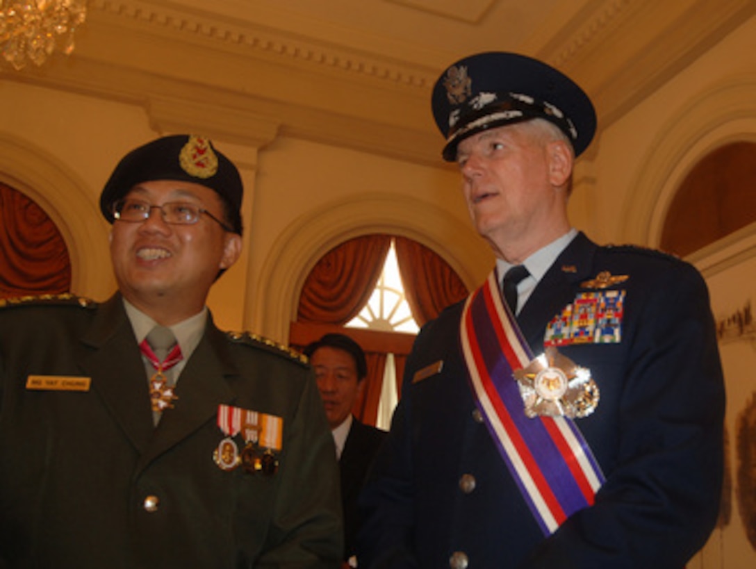 Chairman of the Joint Chiefs of Staff Gen. Richard B. Myers, U.S. Air Force, talks with Chairman of Defense for Singapore Lt. Gen. Ng Yat Chung at the Istana in Singapore on June 3, 2005. Chairman of the Council of Presidential Advisers and Singapore's Acting President Sim Kee Boon earlier awarded Myers the Singapore Distinguished Service Medal at the President's residence. Myers is in Singapore to attend the 4th International Institute for Strategic Studies Asia Security Conference: The Shangri-La Dialogue with Secretary of Defense Donald H. Rumsfeld. The award is the highest that can be given to a foreigner by the Republic of Singapore. 