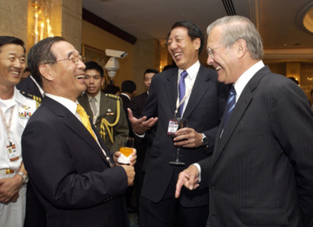 Secretary of Defense Donald H. Rumsfeld (right) shares a laugh with South Korean Minister of National Defense Yoon Kwang-woong, (left) and Singapore Minister for Defense Teo Chee Hean (center) at the opening reception of the 4th International Institute for Strategic Studies Asia Security Conference: The Shangri-La Dialogue in Singapore on June 3, 2005. The Asia Security Conference brings ministers of defense and other senior officials of Pacific nations together to discuss such topics as terrorism, piracy and defense capabilities in the region. 