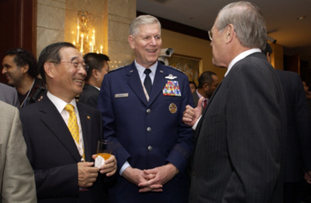 Secretary of Defense Donald H. Rumsfeld talks with South Korean Minister of National Defense Yoon Kwang-woong (left) and Chairman of the Joint Chiefs of Staff Gen. Richard B. Myers, U.S. Air Force, (center) at the opening reception of the 4th International Institute for Strategic Studies Asia Security Conference: The Shangri-La Dialogue in Singapore on June 3, 2005. The Asia Security Conference brings ministers of defense and other senior officials of Pacific nations together to discuss such topics as terrorism, piracy and defense capabilities in the region. 