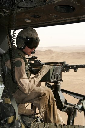 AL QAIM, Iraq ? Lance Cpl. Andy L. Vistrand, a UH-1N Huey crew chief assigned to Marine Light/Attack Helicopter Squadron 269, Detachment Al Qaim scans the ground to find a target while practicing aerial gunnery June 4.  Vistrand, from Panama, N.Y., fires the .50 caliber machine gun every time he?s out flying to improve his accuracy and ensure the weapon functions properly.