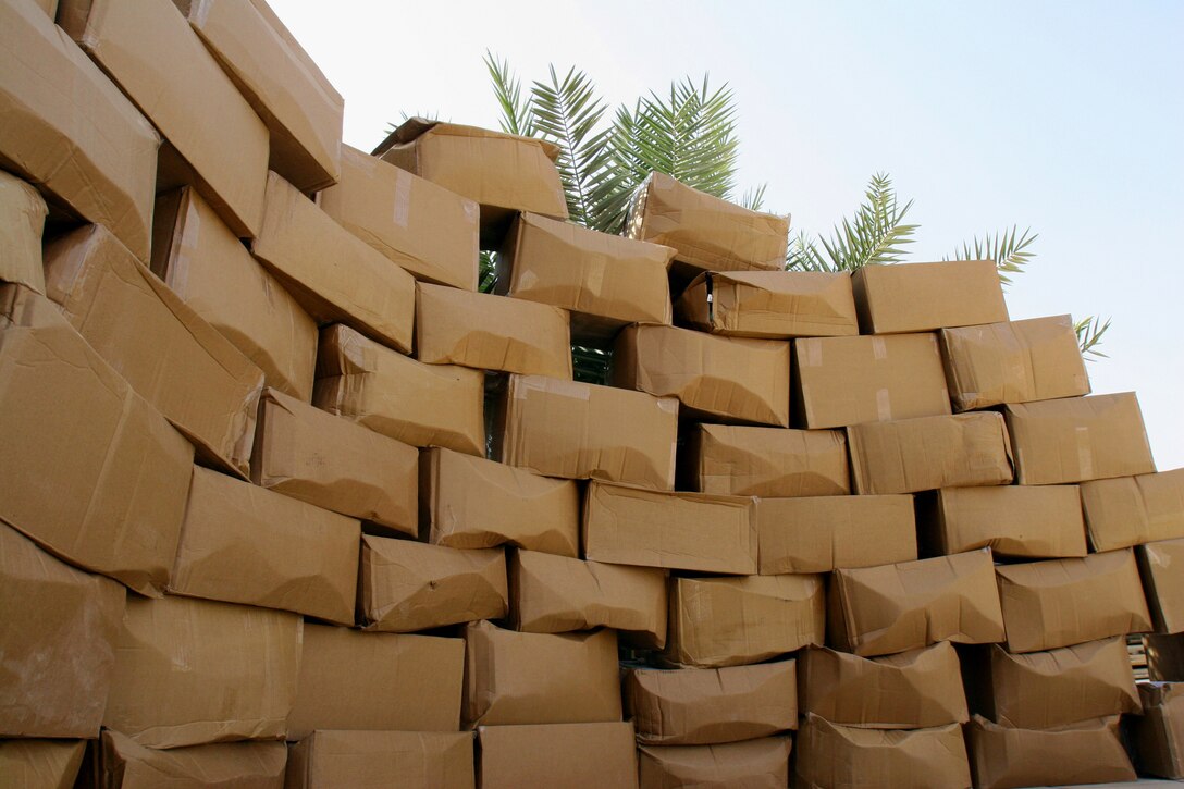 AL ASAD, Iraq - A mountain of boxes rises from the Iraqi desert.  The boxes are full of items that Marines deployed here relish and are very hard, if not impossible to get.  The huge shipment of boxes is part of Wilmington (Downtown) Rotary Club?s ?Mission Iraq Marine.?  This is the third shipment of packages made by the Wilmington N.C. Rotary club.  The club intends to continue sending packages through early September.