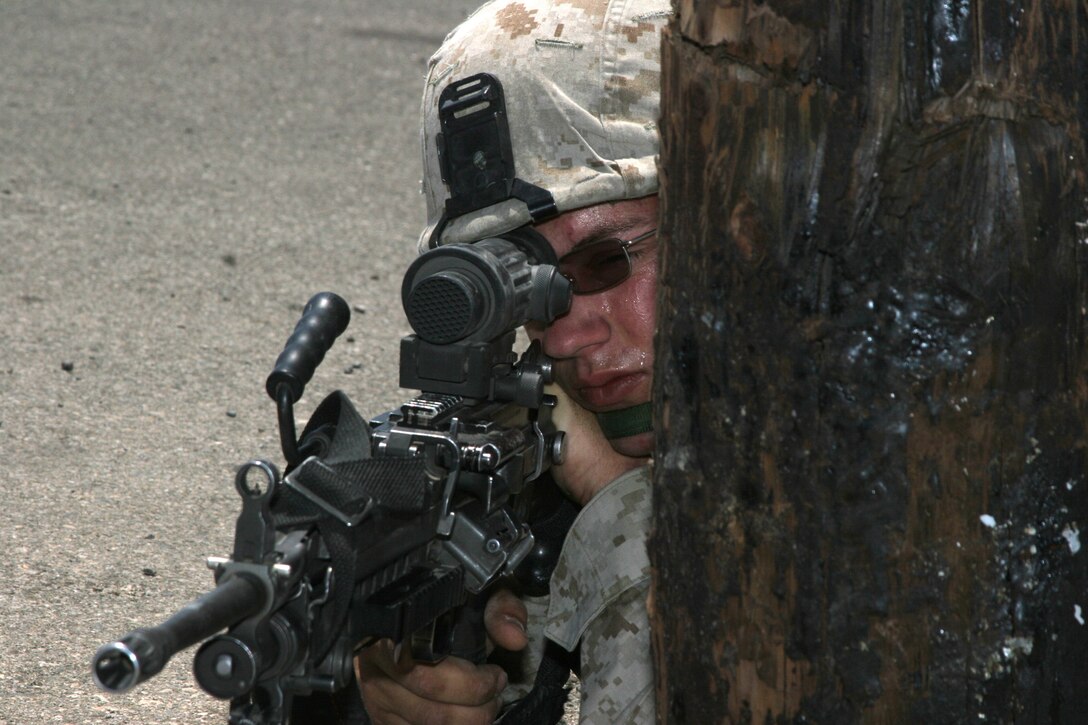 Pfc. Rory J. Yanulis, rifleman, Lima Company, 3rd Battalion, 7th Marine Regiment, provides security for his team on a patrolling exercise on Mainside June 7.