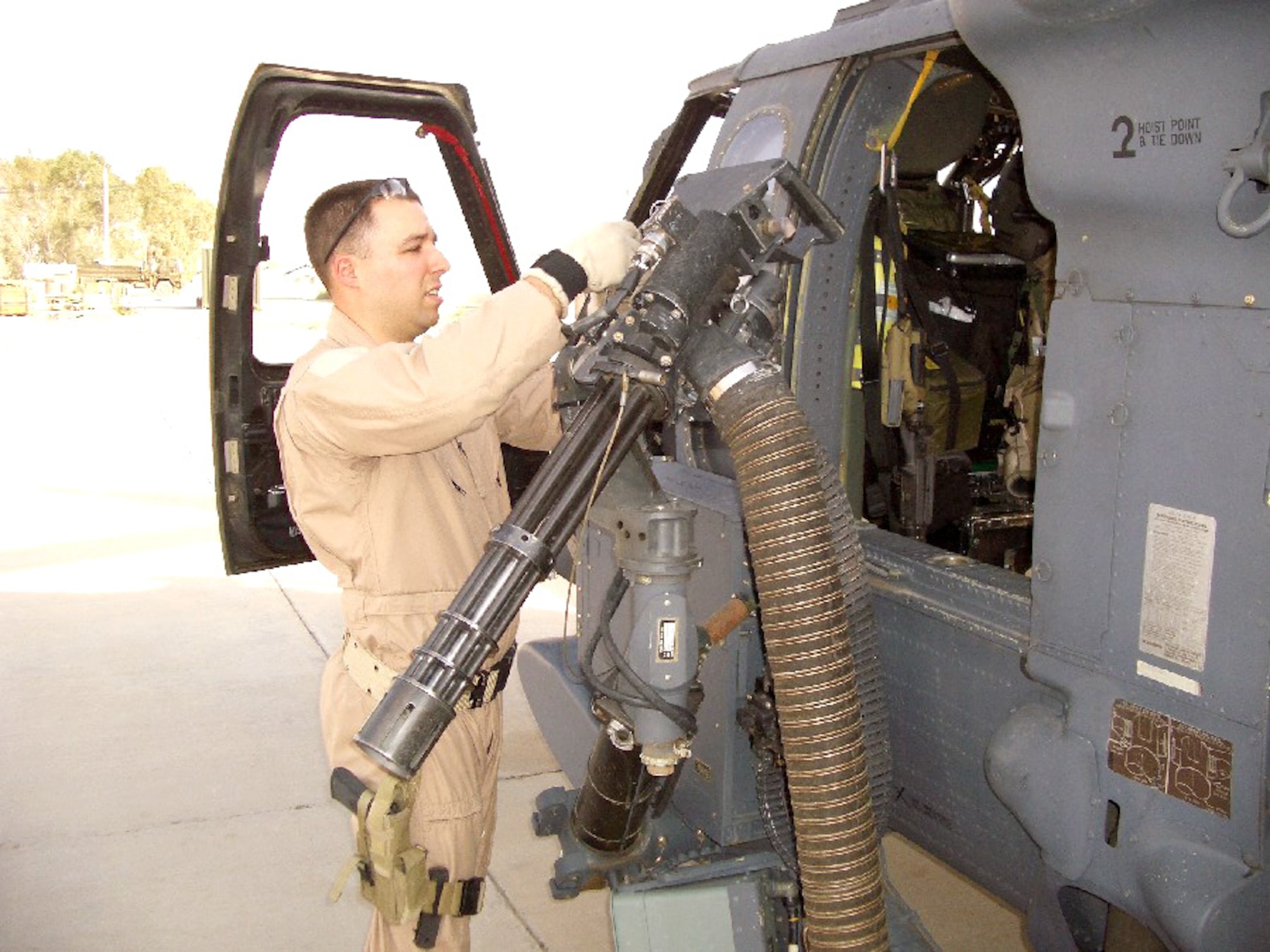 KANDAHAR AIRFIELD, Afghanistan -- Tech. Sgt. Jason Burger checks out the weapon systems on an HH-60G Pave Hawk before a night mission.  He is a flight engineer with the 451st Air Expeditionary Group here and is deployed from the 305th Rescue Squadron at Davis-Monthan Air Force Base, Ariz.  (U.S. Air Force photo by Col. Eric W. Vollmecke)