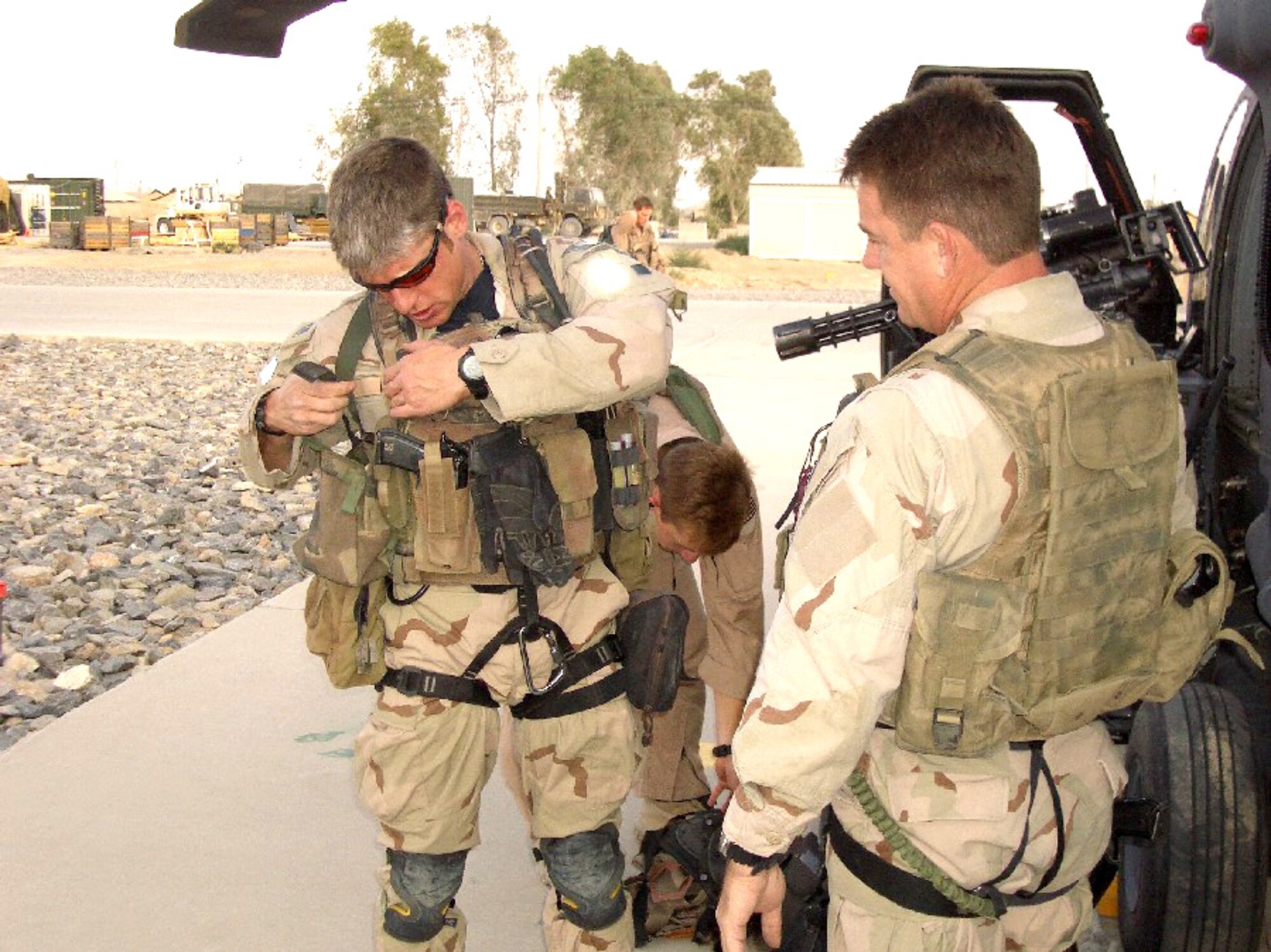 KANDAHAR AIRFIELD, Afghanistan -- Senior Airman Chris Piercecchi (left) adjusts his survival vest before a rescue mission as Senior Master Sgt. Jim Sanchez watches.  They are pararescuemen with the 451st Air Expeditionary Group here and are deployed from the 305th Rescue Squadron at Davis-Monthan Air Force Base, Ariz.  (U.S. Air Force photo by Col. Eric W. Vollmecke)